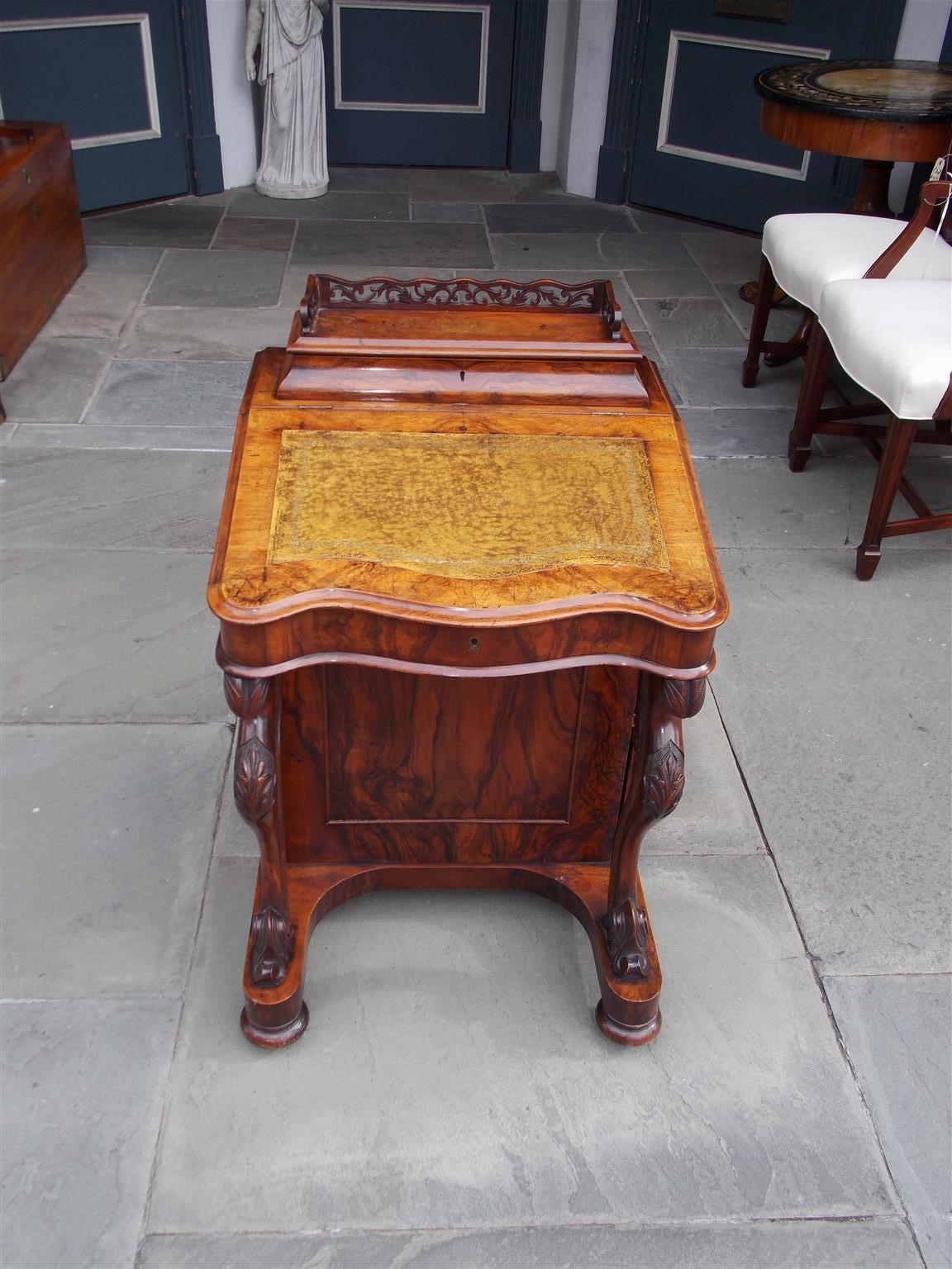 English burl walnut Davenport desk with carved floral fret work, hinged lid revealing fitted interior with original ink wells, leather hinged writing surface with four fitted interior drawers, hinged side door with four interior sliding drawers and