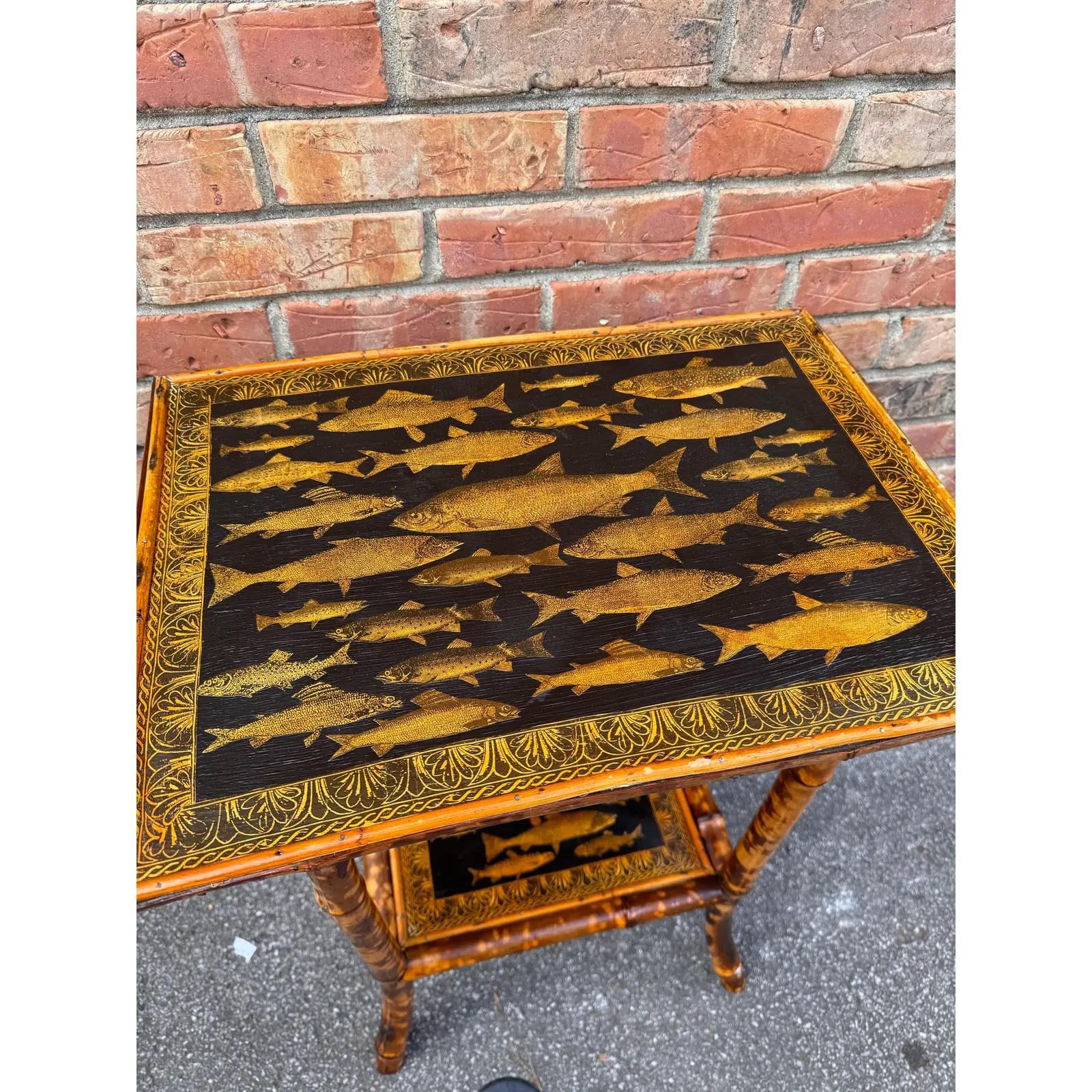 This is a beautifully decoupage English bamboo side table rectangle in shape. The canary yellow of the decoupaged fish against the black background in combination with the burnt bamboo gives this table, such a great appearance. English bamboo is
