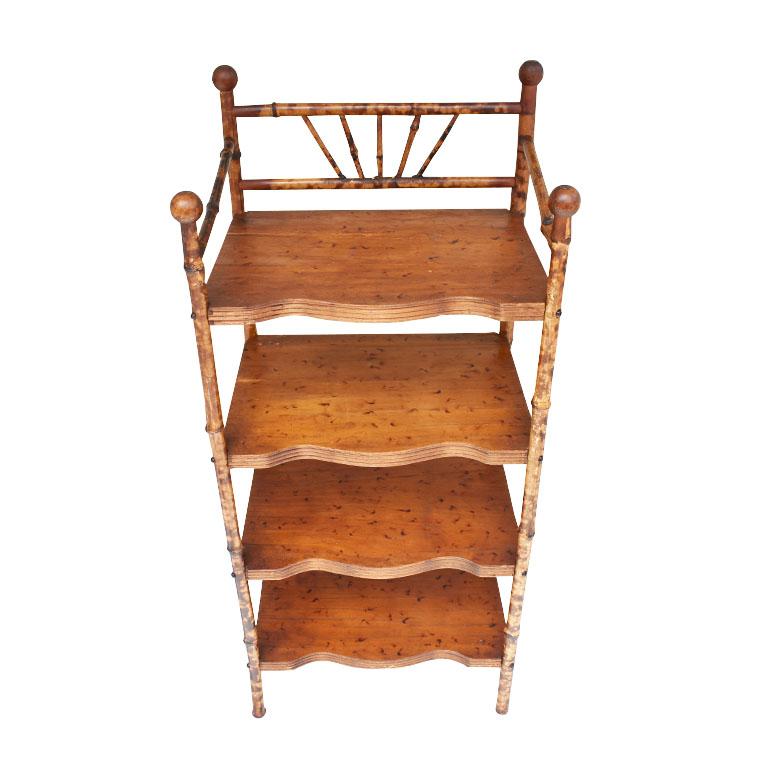 A grand millennial's dream come true! This early Victorian English burnt bamboo bookshelf will be the chicest way to add extra storage to any space. With four shelves, this shelf has plenty of room for all of your favorite items. Each shelf has a