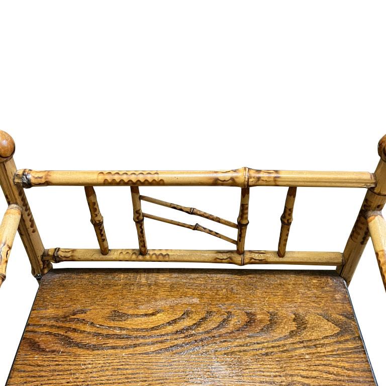 A grand millennial's dream come true! This early Victorian English burnt bamboo bookshelf will be the chicest way to add extra storage to any space. With 4 shelves, this bookcase has plenty of room for all of your favorite items. Each shelf is a