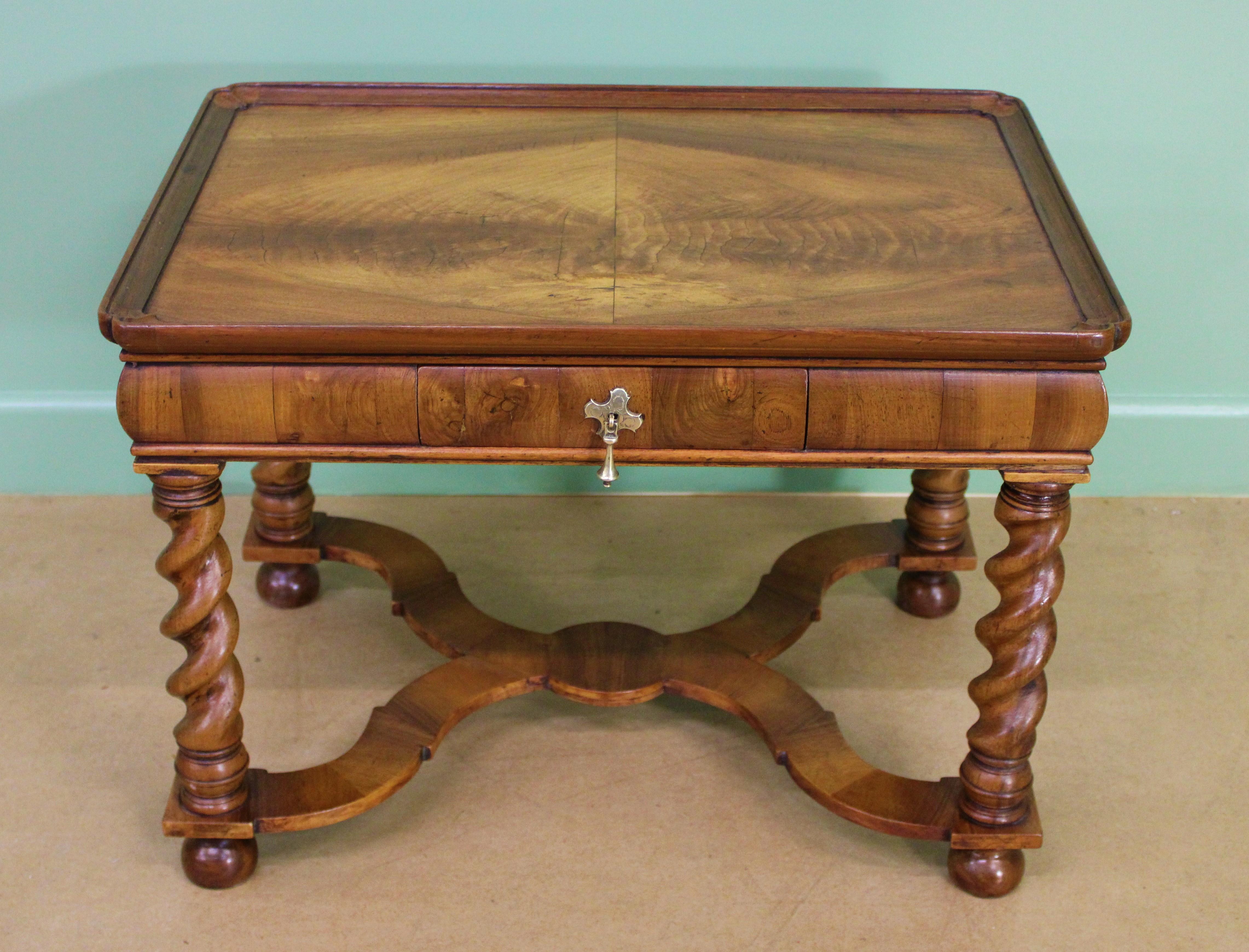 A charming burr walnut coffee table in the William and Mary style. Very well constructed in solid walnut and attractive burr walnut veneers. With a drawer to the freeze, fitted with its original solid brass handle. Standing on barley twist legs,