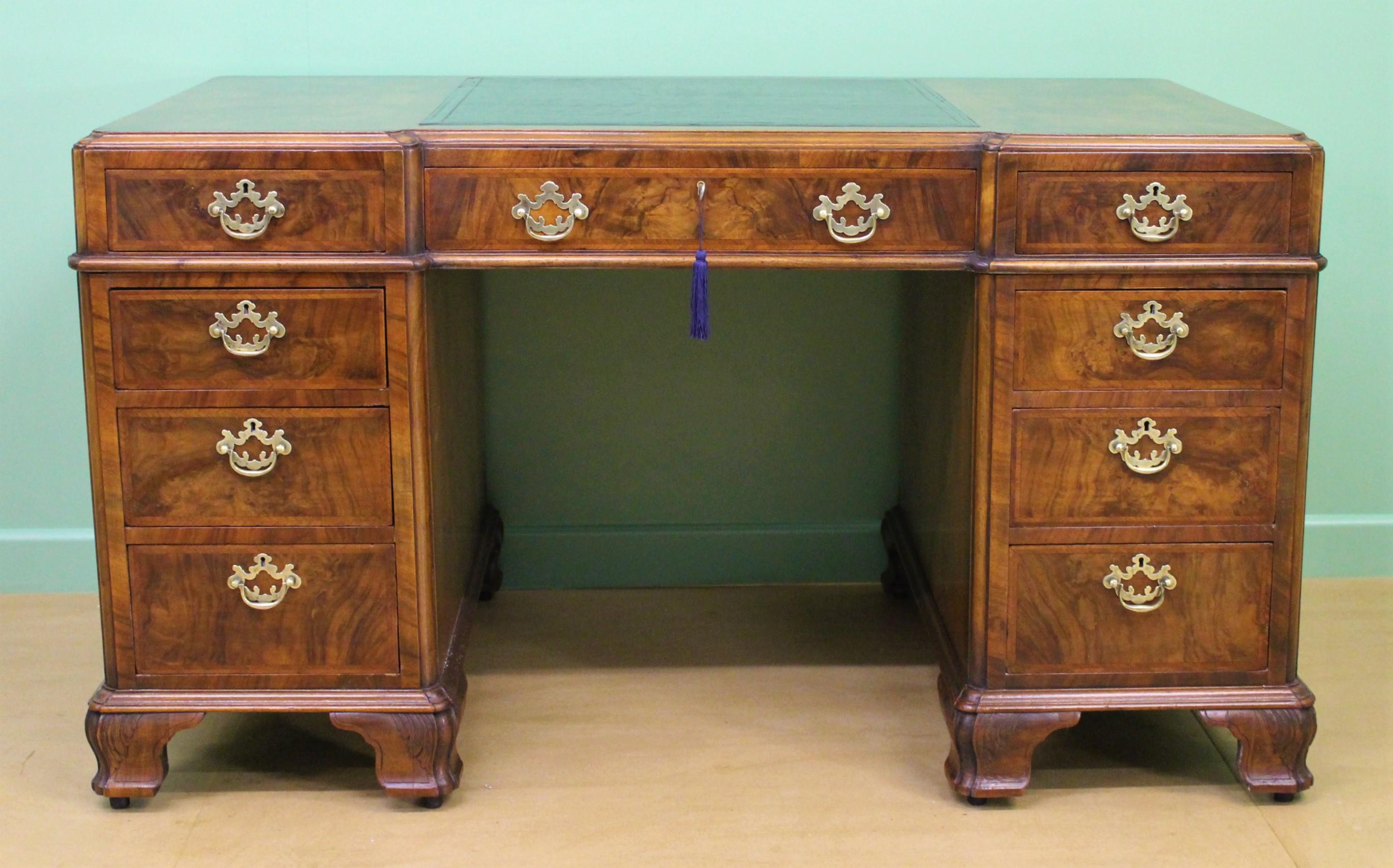 A superb quality burr walnut pedestal desk by the prestigious firm of Maple and Co. of excellent construction in solid walnut, with stunning burr walnut veneers and oak lined drawers. There is an arrangement of 8 short and one long, central, drawer