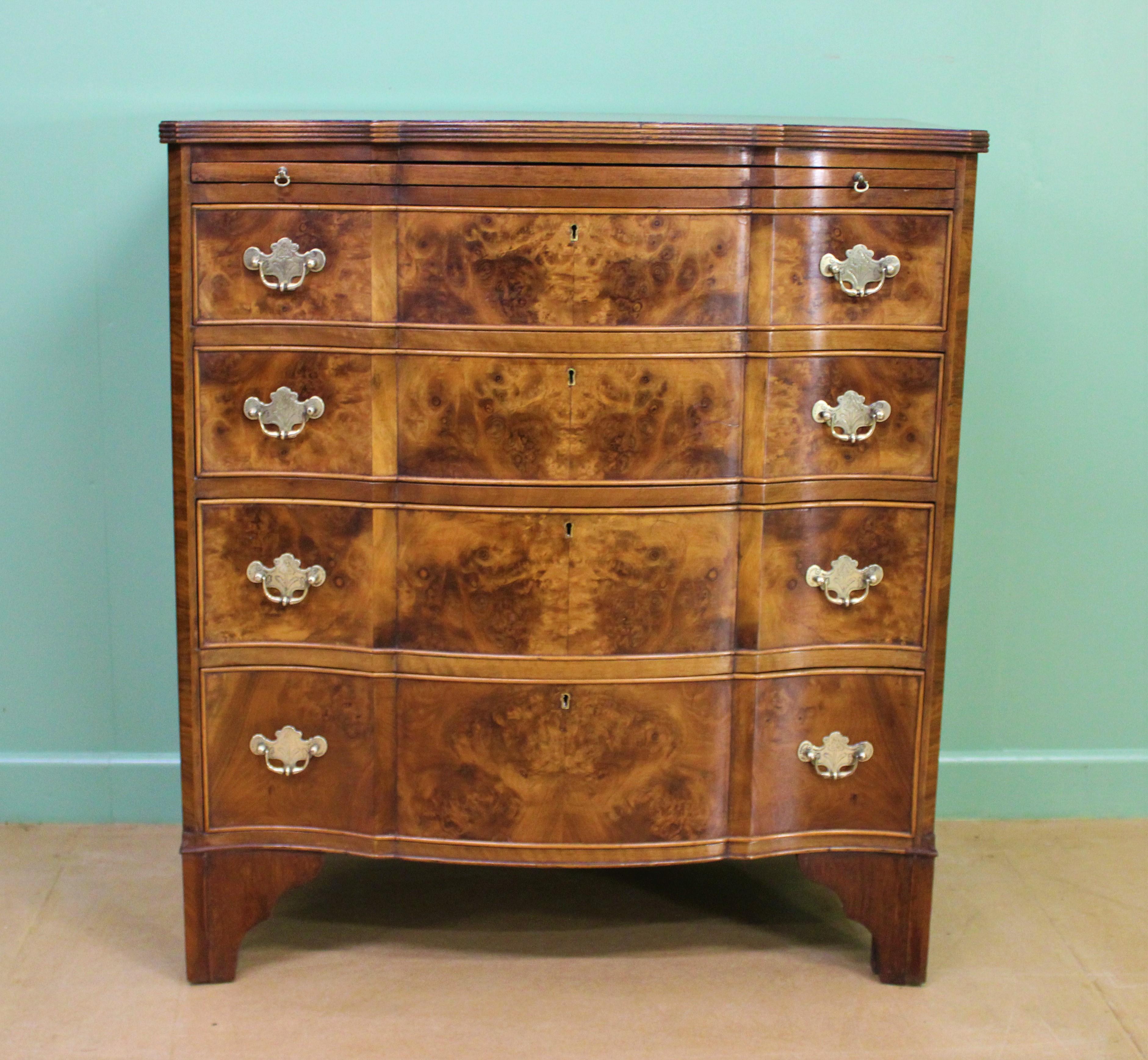 A very good early Georgian style burr walnut serpentine fronted chest of drawers. Well made in solid walnut with attractive burr walnut veneers. With an arrangement of 4 long , graduated drawers and a brushing slide. All fitted with their original