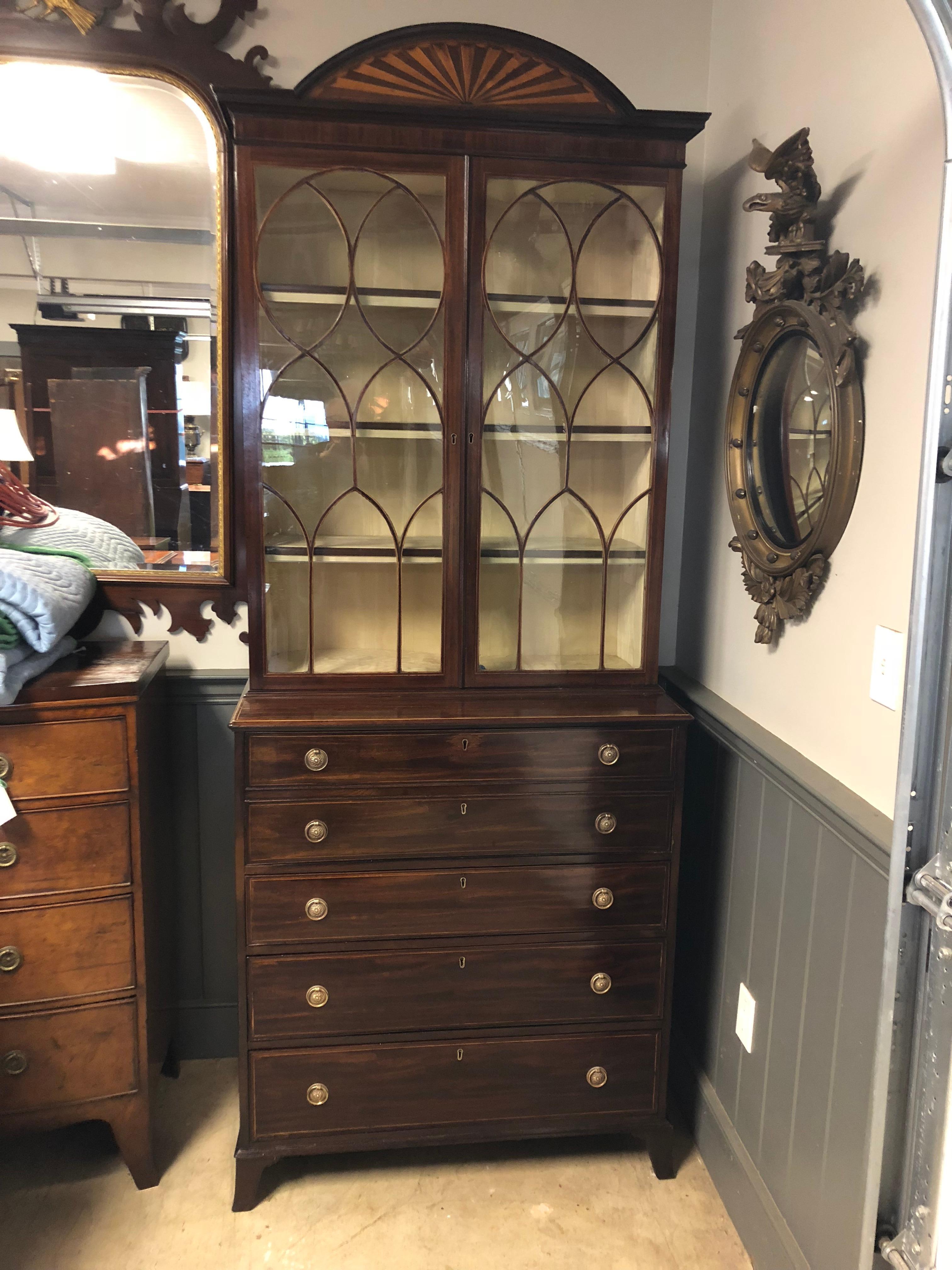 English Butler's secretary in dark mahogany with inlay stringing on each drawer and around the top edge, incredible fan centered on the cornice with inlaid woods, beautiful glass pattern with inlaid mahogany, interior pigeon holes and leather,