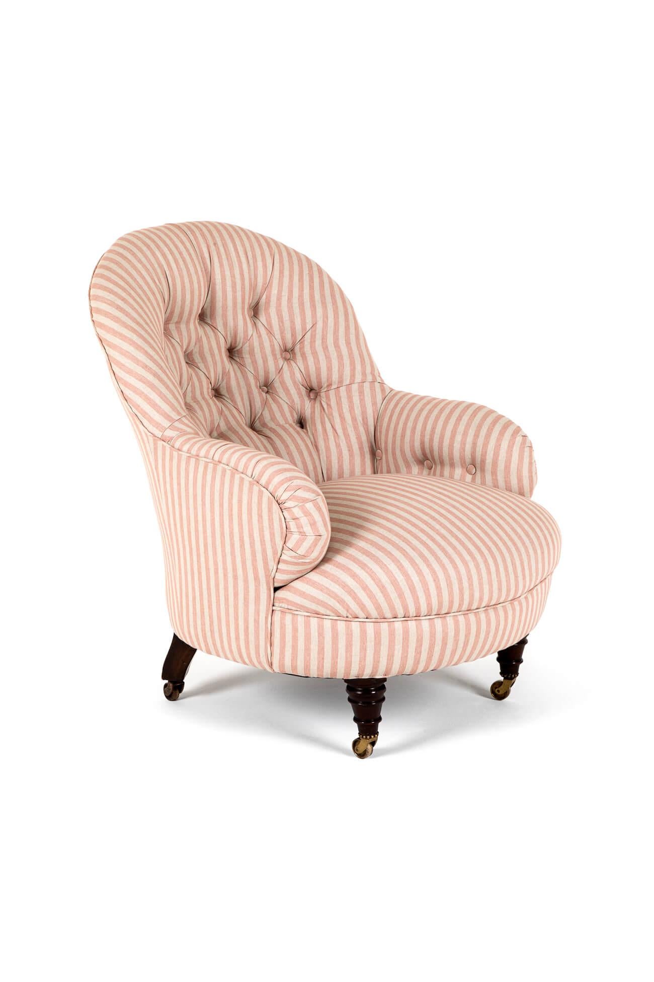 A generously proportioned over stuffed Cornelius V. Smith button back armchair in pink stripe linen.

Mahogany turned front legs and splayed back legs, all raised on original brass castors. The back leg is stamped clearly with the makers mark CVS