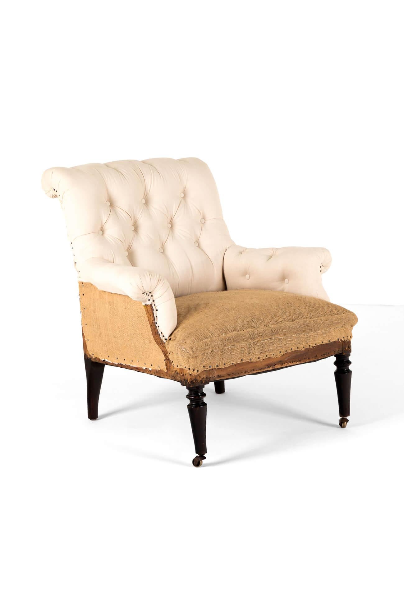 A splendid deconstructed Victorian deep armchair with a strong oak frame with featuring a high scrolled button back, scrolling arms and an inviting wide and deep seat.

The turned front legs are raised on original brass castors giving the chair a