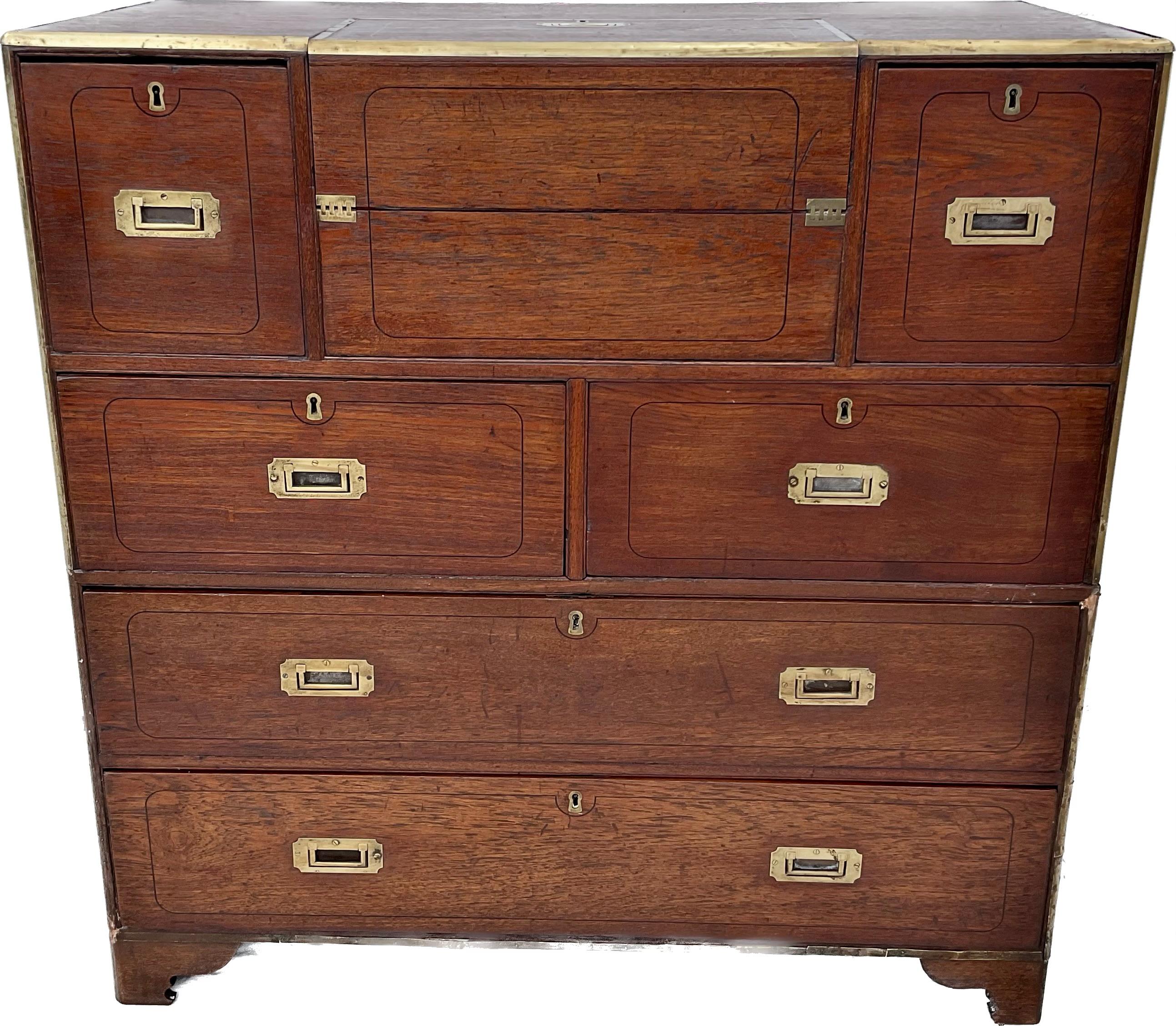 Spectacular English Campaign Chest - ship captain's desk / chest in two parts. The top central drawer contains a drop-front desk surface with multiple small drawers and secret compartments. Bottom of chest contains two large drawers. Brass mounts