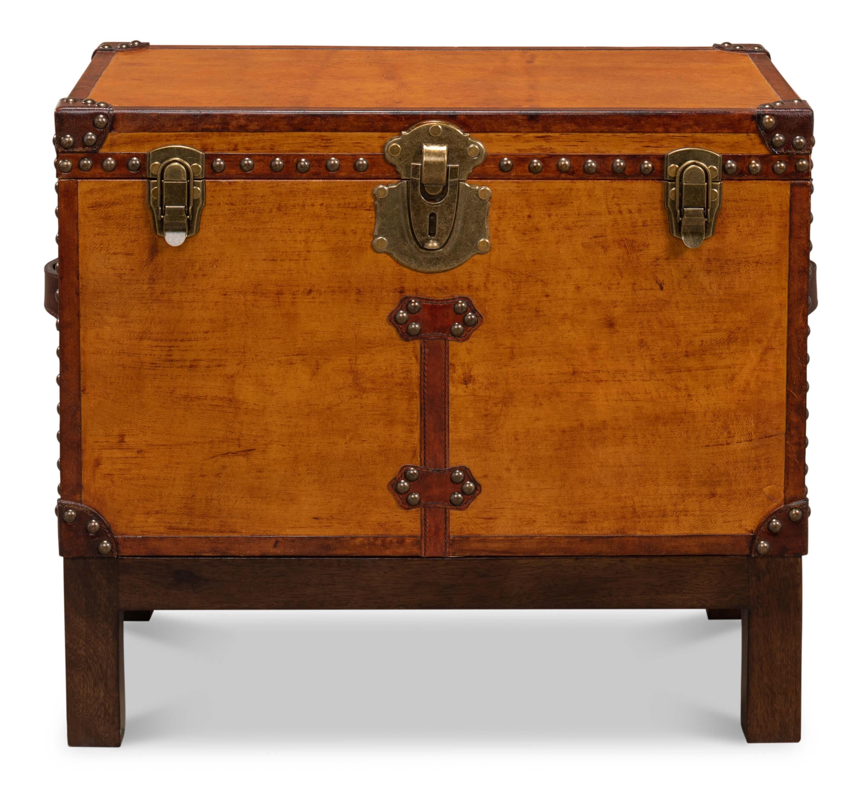 An English Campaign style decorative box on stand, this smaller wood box is beautifully detailed with brass tacks and hardware with leather accents. The interior of the box is lined with decorative paper. It rests on a wood stand. 

Dimensions: