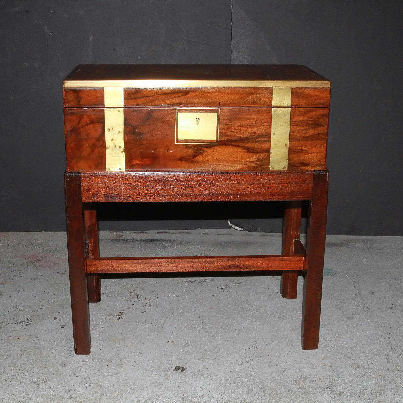 An English walnut brass bound Campaign form lap desk on stand. The interior with tooled leather writing surface and fitted compartments and raised on a later mahogany stand. Ca 1830's

Dimensions: 19.75