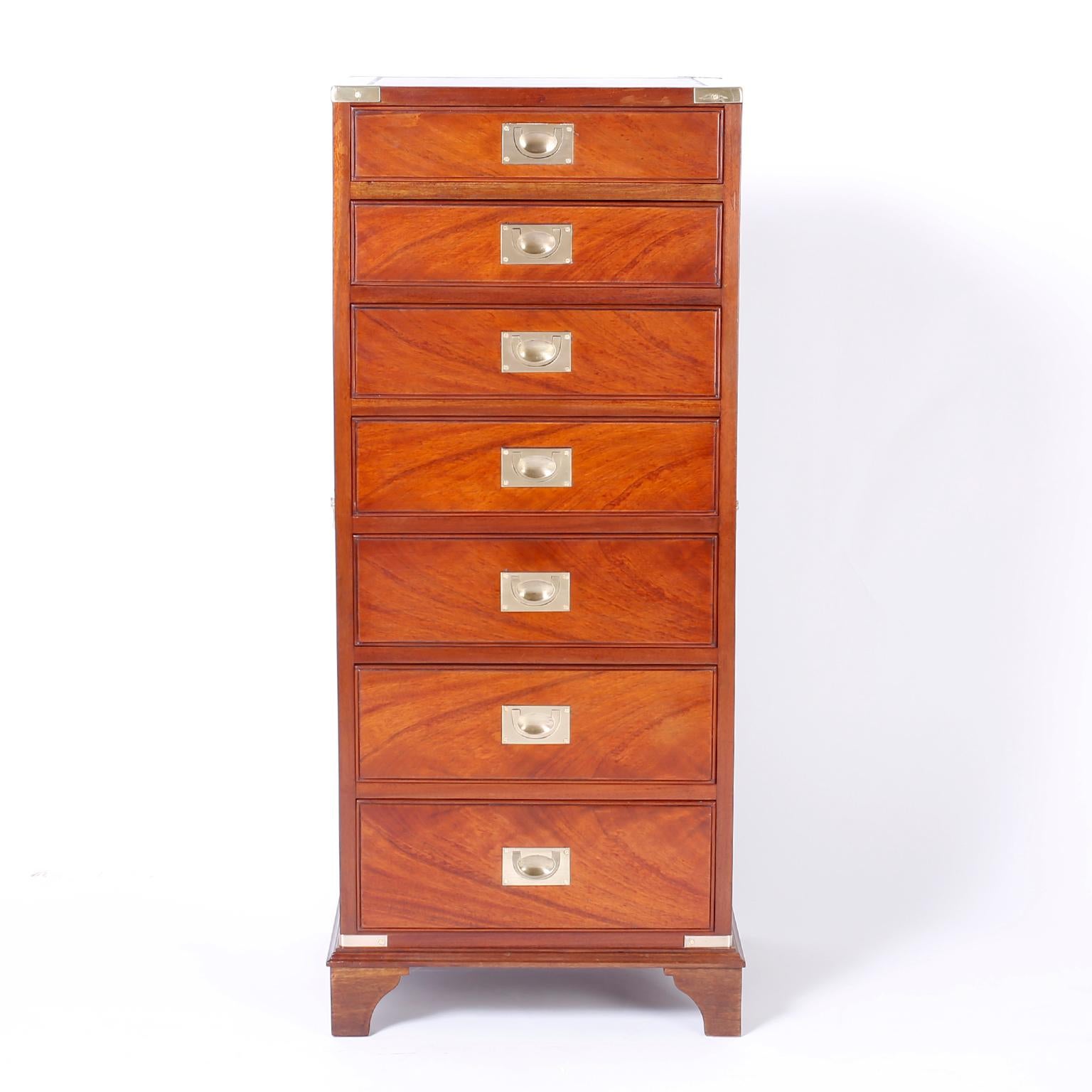 Antique English seven-drawer lingerie chest crafted in mahogany with flame grained side panels, tooled leather top, brass hardware, elegant form and bracket feet.