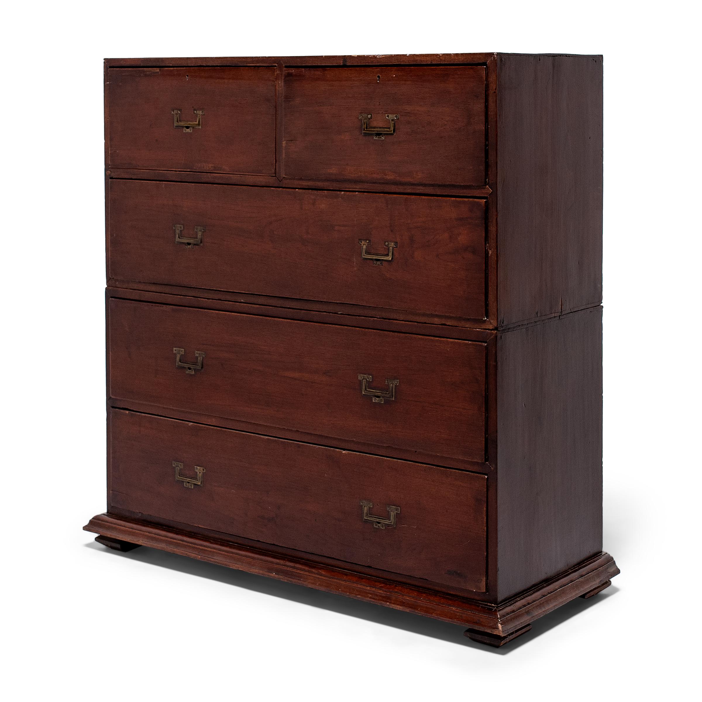 This fantastic two-piece chest of drawers dates to the late 19th century and originated as a military campaign chest, designed to follow dimensional requirements set by The British Army General Order of 1871. The cabinet is comprised of two separate