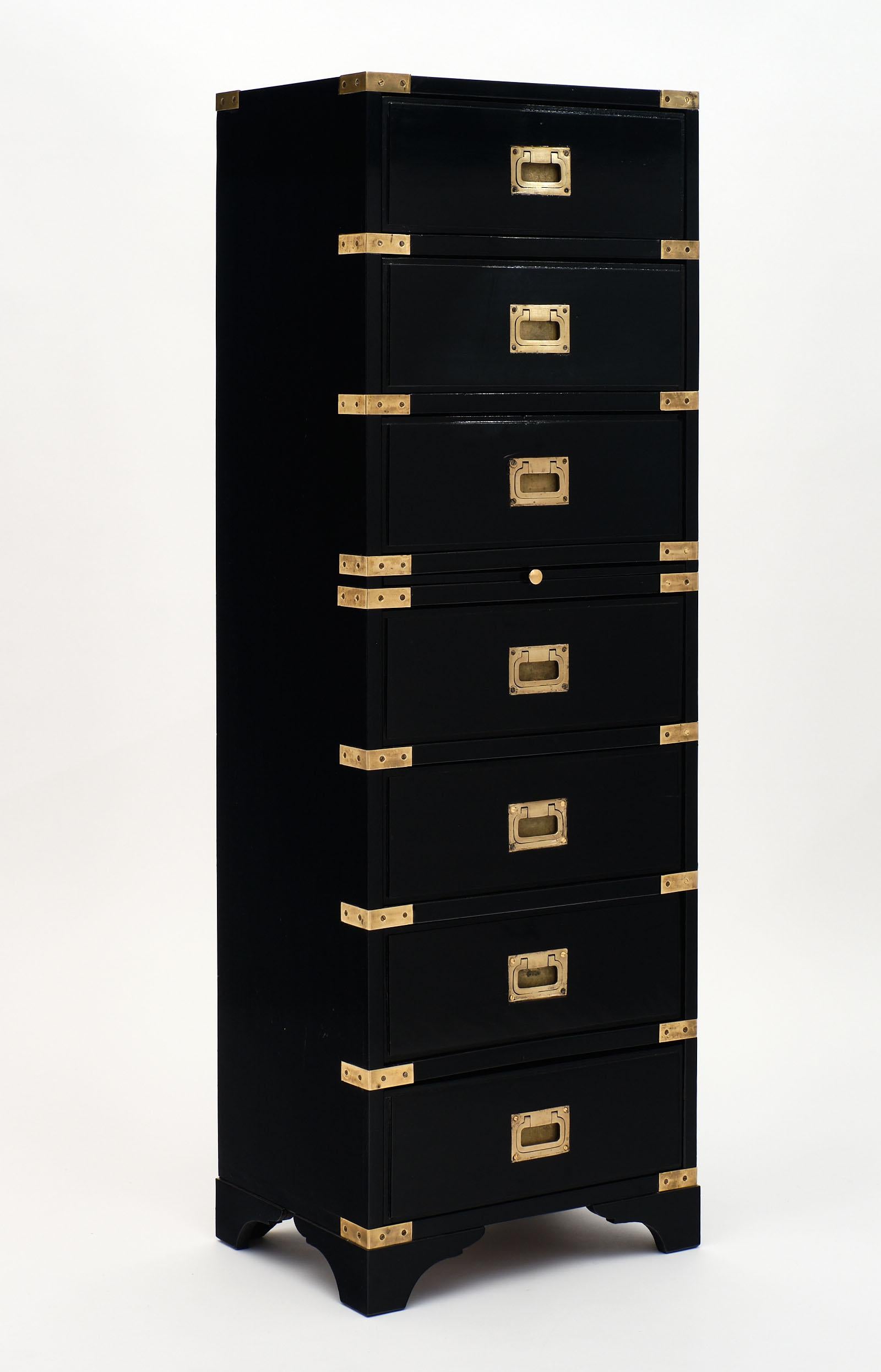 English Campaign style semainier made of cherrywood. This elegant cabinet features seven dovetailed drawers with original solid brass hardware and a writing pullout tablet. The piece has been finished with a lustrous ebony French polish.