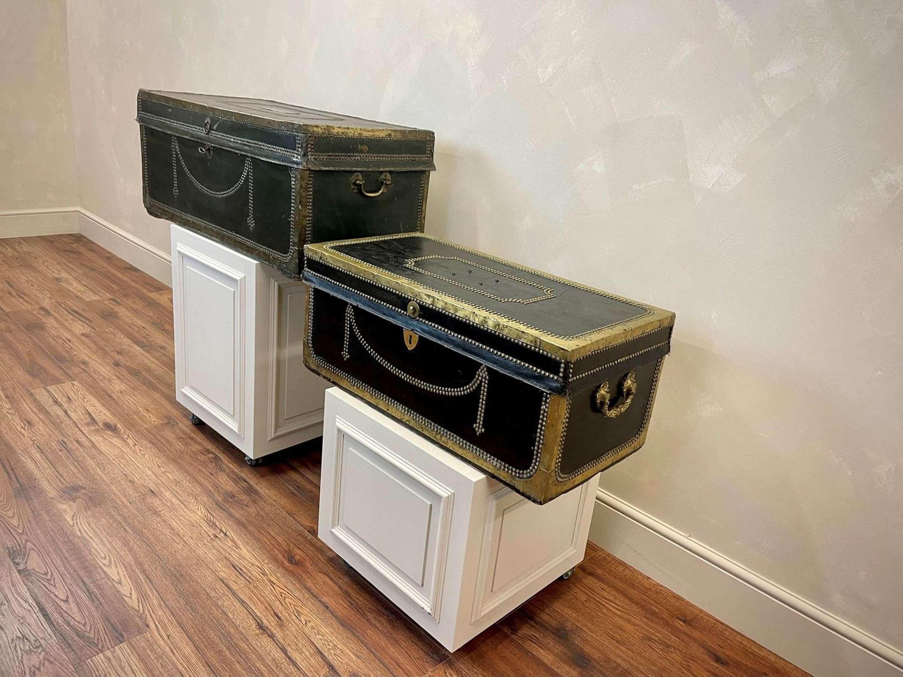 Two large leather camphor trunks, circa 1830. One dark green and one black leather, both bound and decorated in brass with swag nail head detailing. Both clean inside.
Manufactured by the British East India Company for an officer to carry his kit
