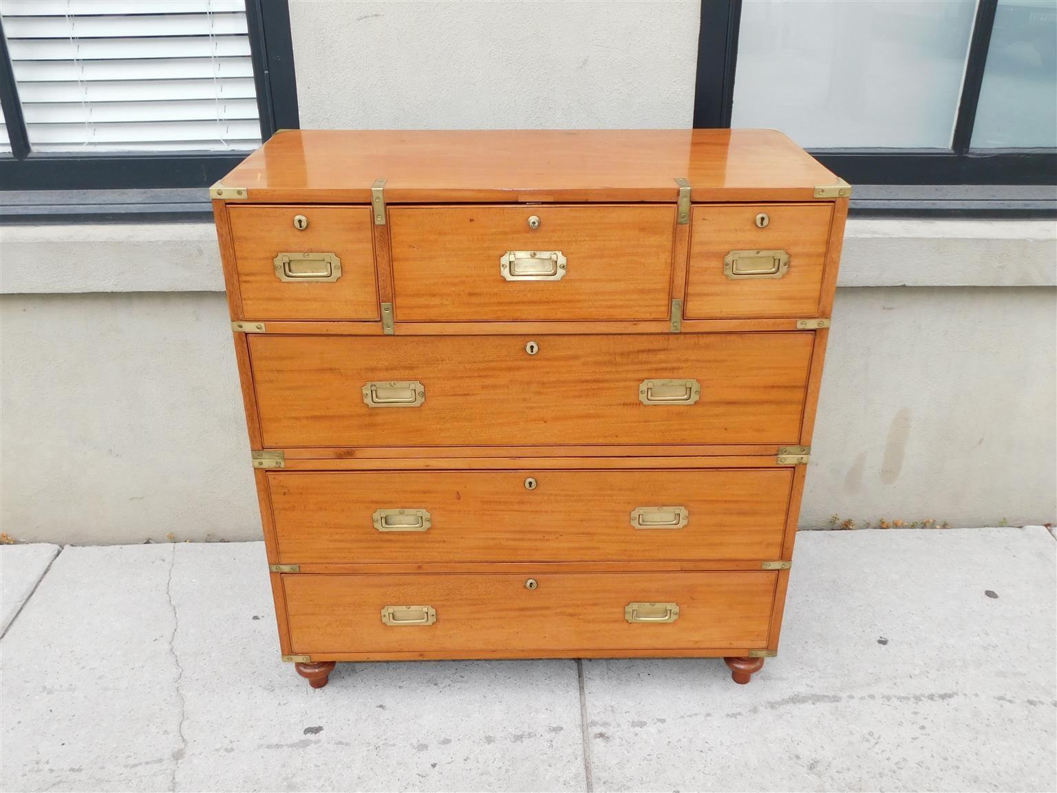 English camphor wood and mahogany military campaign chest with an upper case central fitted hinged fall front secretary desk revealing a leather writing surface, flanking pigeon holes, three interior drawers with pulls, two flanking drawers, three