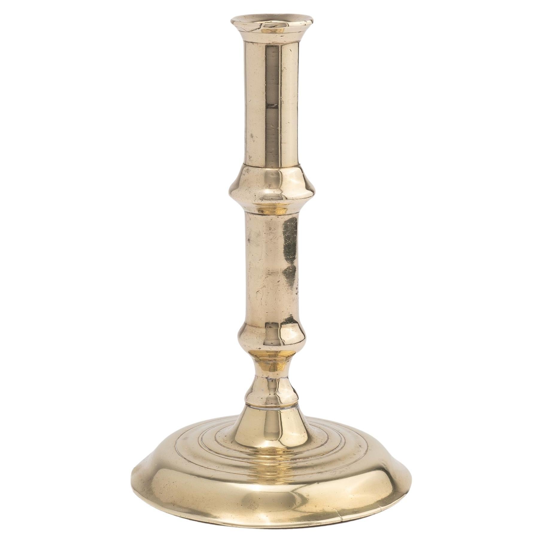 English canon barrel brass candlestick on domed base, 1720-40 For Sale