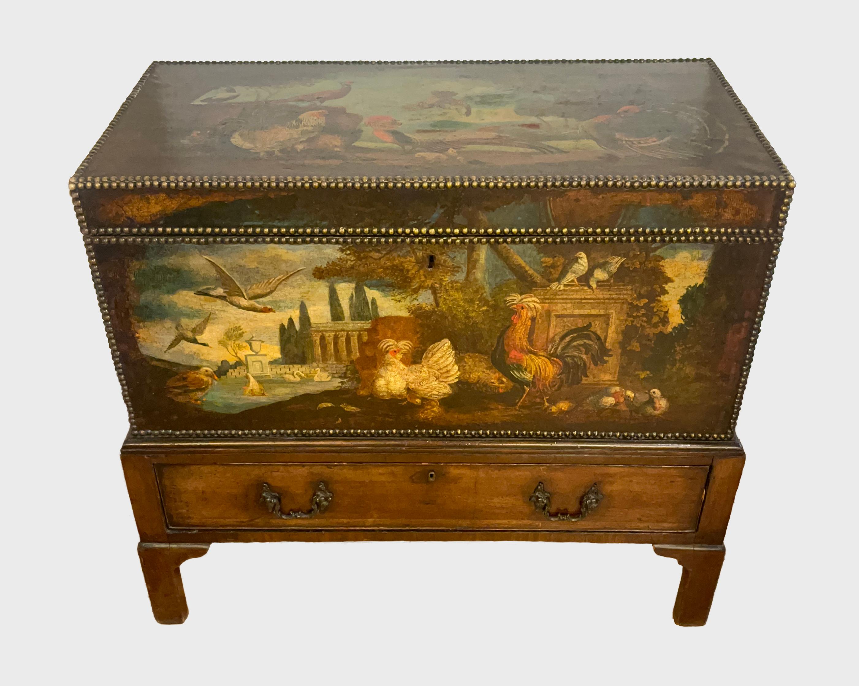 English painted leather carriage trunk on stand 18th/19th c. and adapted, the leather chest with brass close-nailed edging, painted on four sides with game foul garden setting, on mahogany stand with single long bracket feet
 