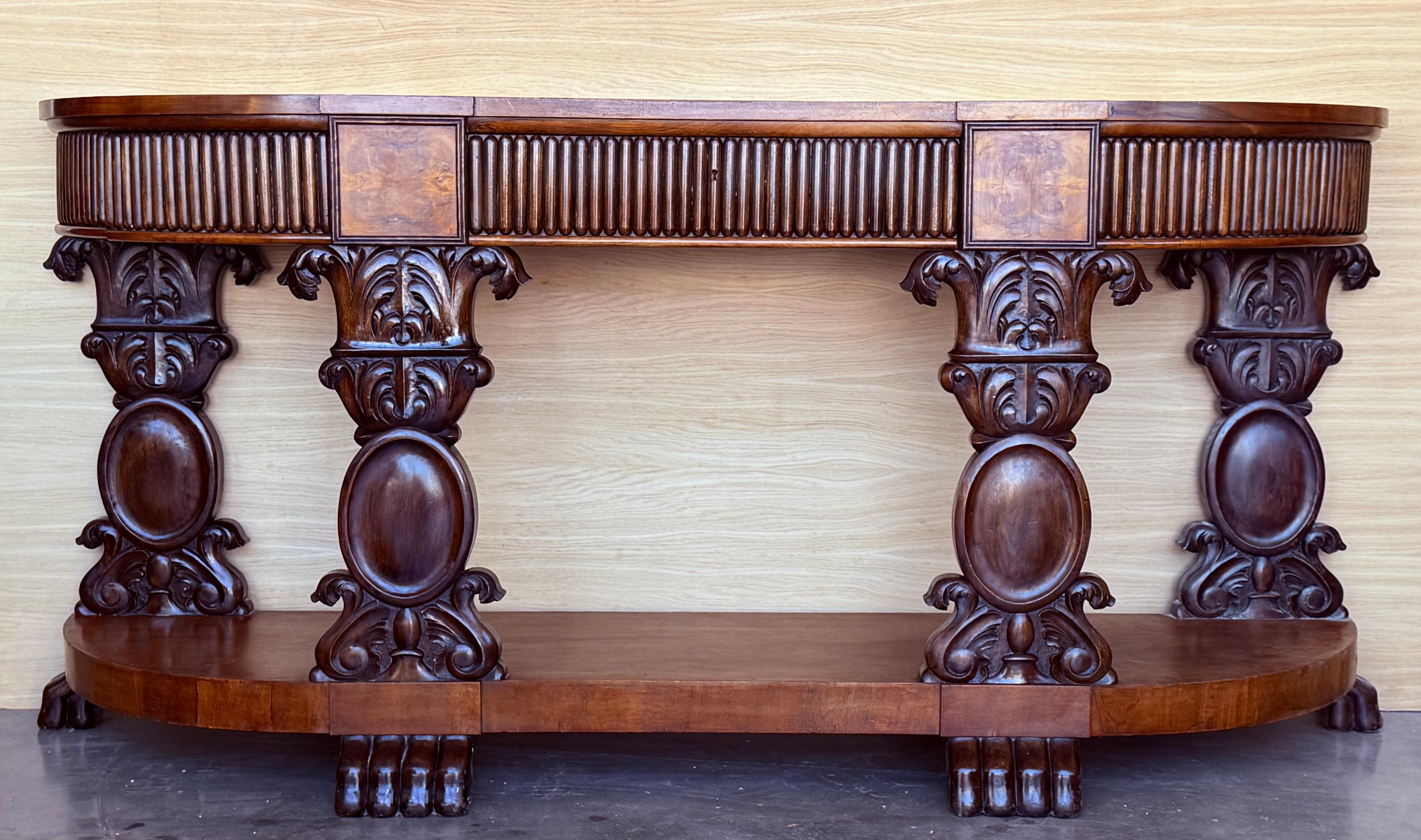 English Carved Console with three drawers.
 The console is raised on four pedestal legs with medallions details in a large base with pawn legs, it has three large drawers.