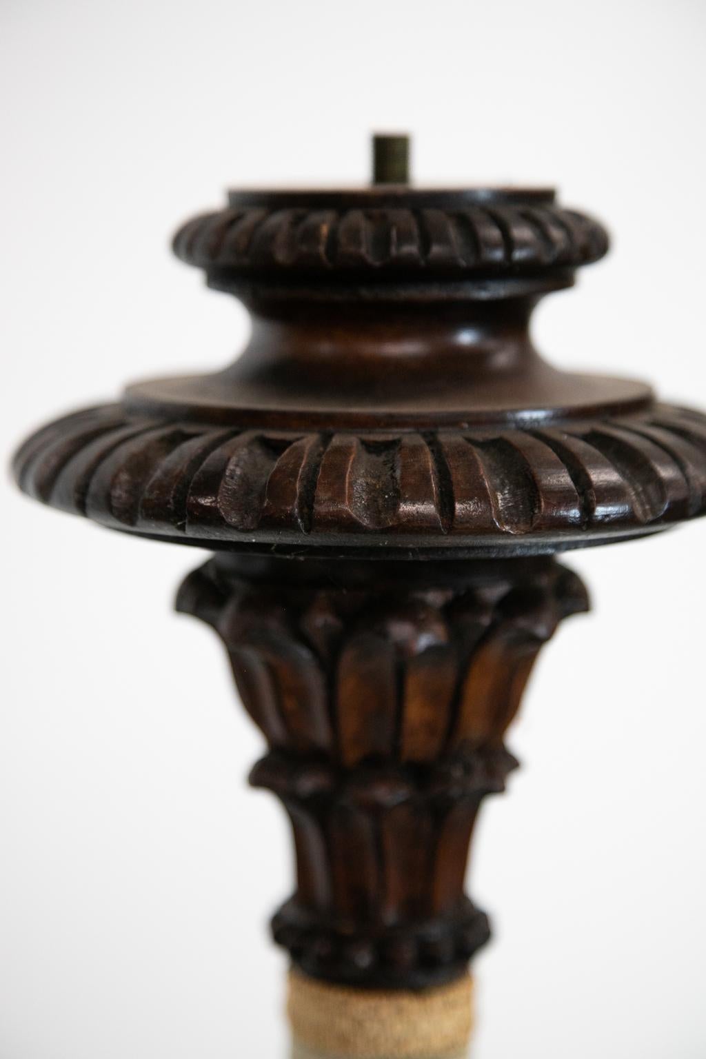 This floor lamp has a carved reeded dome shaped base with a center carved knop and a carved crown with stylized leaf motifs. The center pedestal was covered with light green velvet, but the gemp lining has deteriorated and would probably need to be