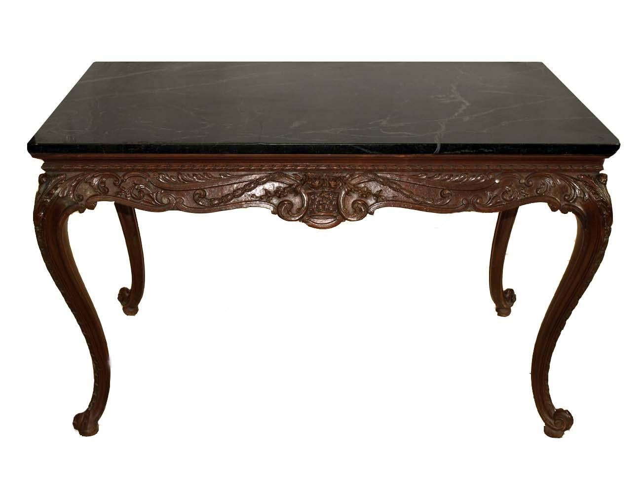 English carved marble top center table, the verde marble top with beautiful veining, the base is carved in high relief on all sides featuring foliate, arabesques, and bell flower, the legs with carved knees with trailing bell flower carving