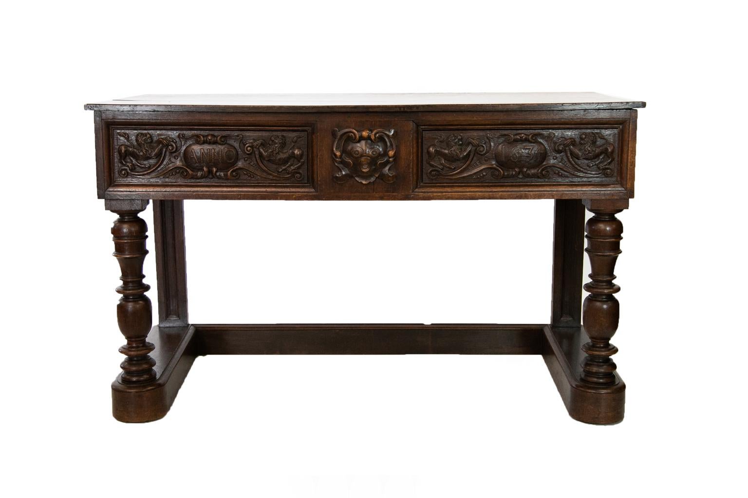 The drawers of this English oak carved console table have lions and cartouches carved in high relief. The cartouche is carved with 
“anno1634”, which is not the correct age of the piece. The sides are carved with stylized birds and arabesques.
 