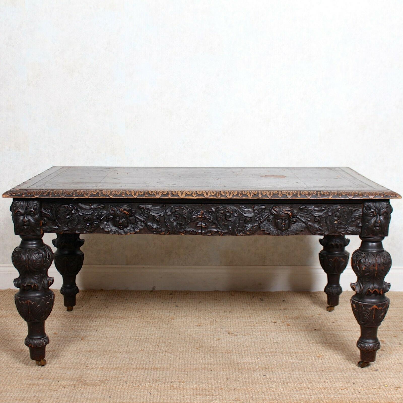 An impressive 19th century carved oak library table in the Jacobean manner.

The rectangular top with inset tooled leather writing surface and acanthus carved edges. Fitted two foliate carved frieze drawers and raised on carved baluster legs