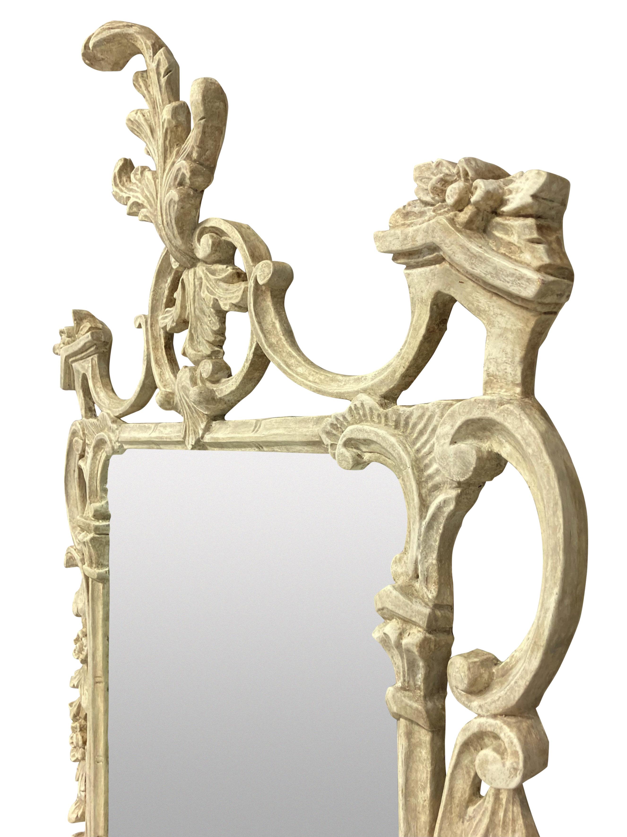 An English finely carved and painted Chippendale style mirror, in an ivory colour, with a later mirror plate.