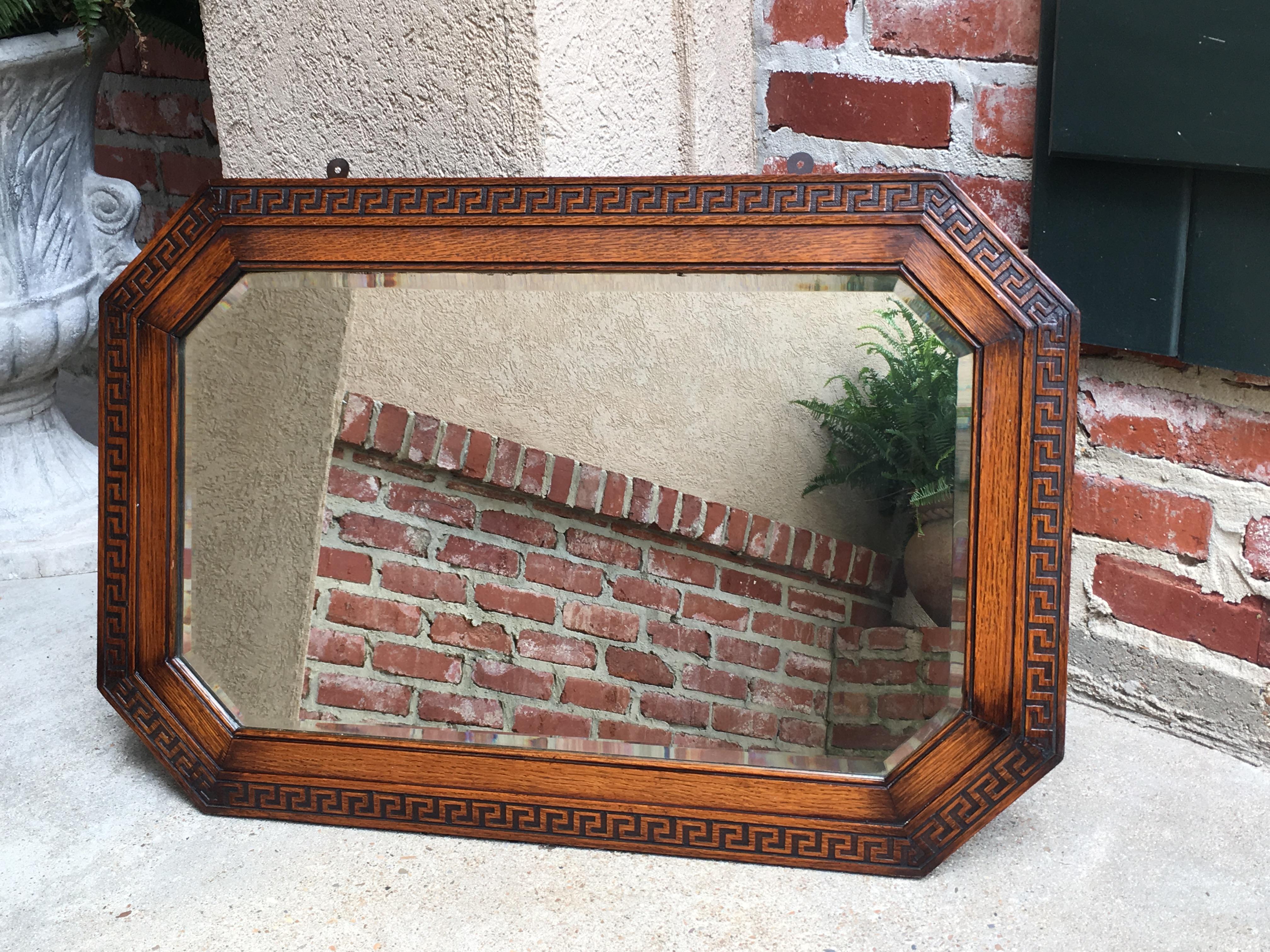 Direct from England, a lovely antique English oak frame wall mirror, in traditional Jacobean octagon shape, with stunning Greek Key carved band around the entire eight-sided edge!
~ Original beveled mirror
~ Hangs either way, horizontally or