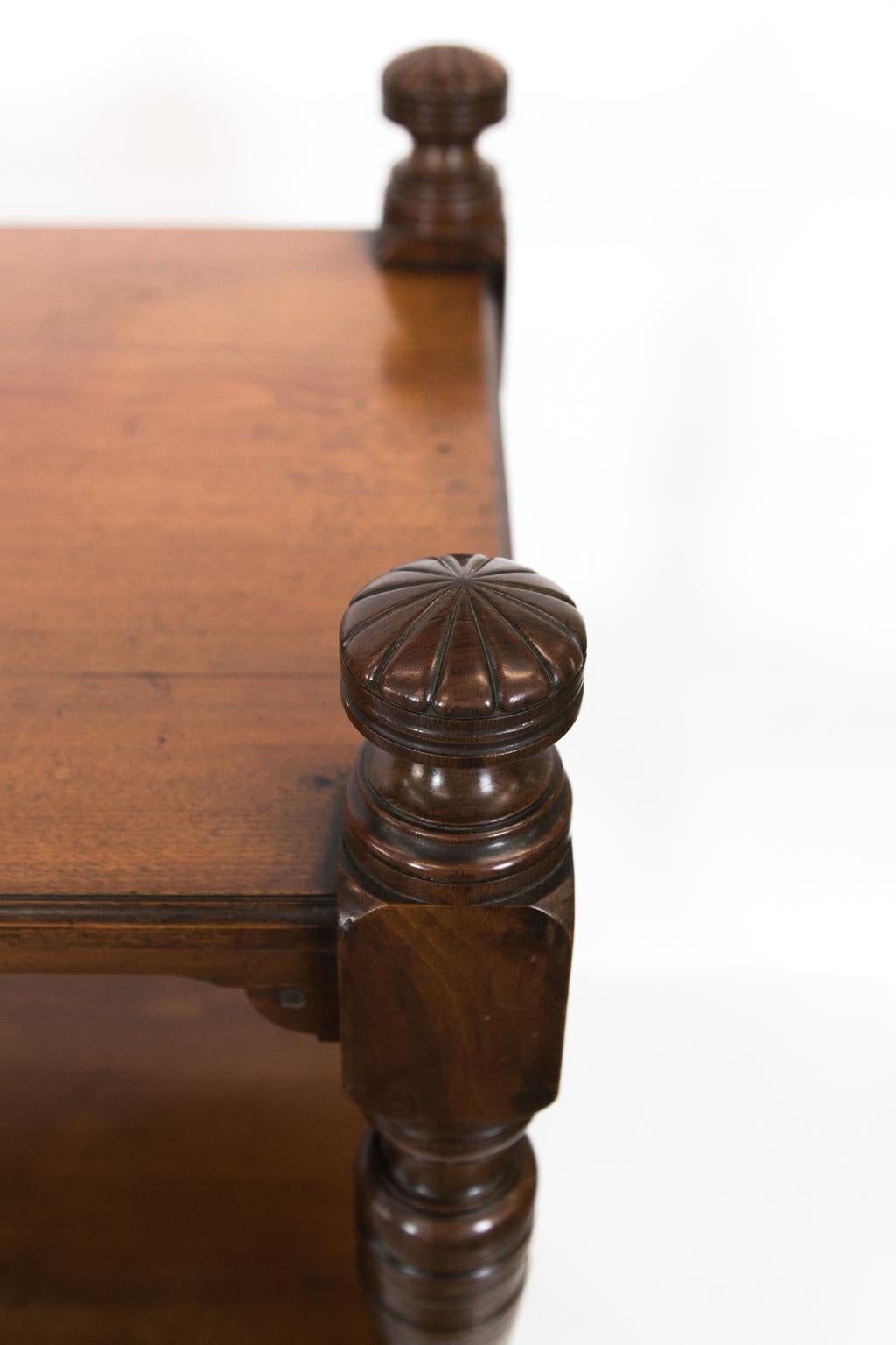 English carved walnut three-tier shelf, with the mushroom finials having carved sunbursts on top. There are aprons on each shelf with carved edge molding. All four legs are very nicely turned and are three inches in diameter. The side legs have