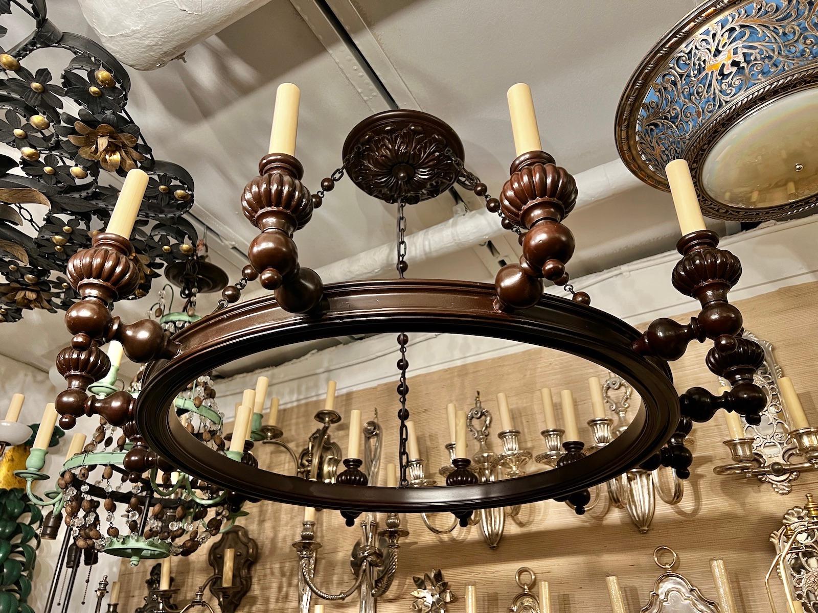 A circa 1940’s English neoclassic style carved wood chandelier with bronze chain.

Measurements:
Height: 23″
Diameter: 35″