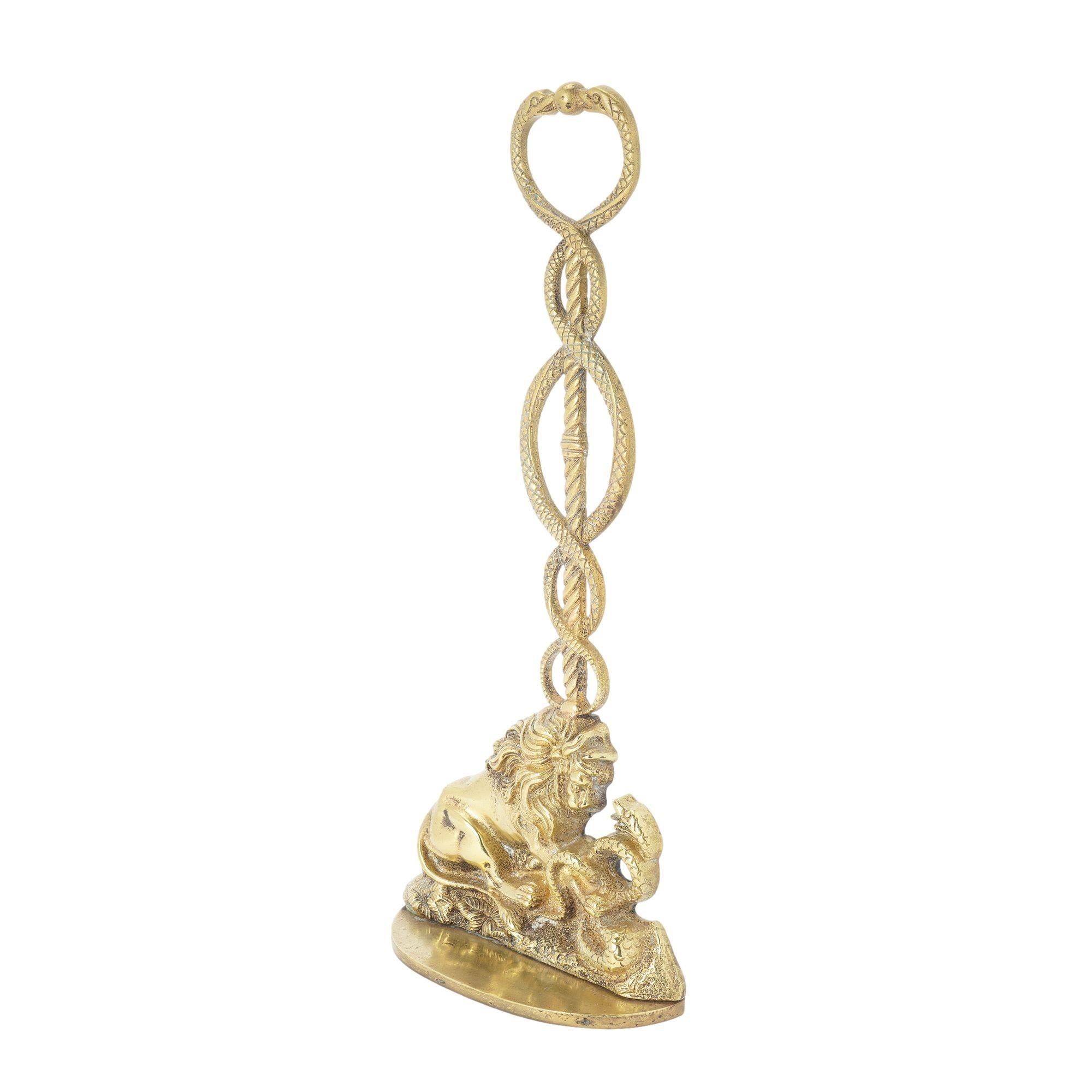 Cast brass and lead weighted door stop of a lion confronting a snake, centered on a caduceus with the two snake heads forming a loop handle. The casting is in fine original condition with excellent detail.

English, Regency period, circa 1820.