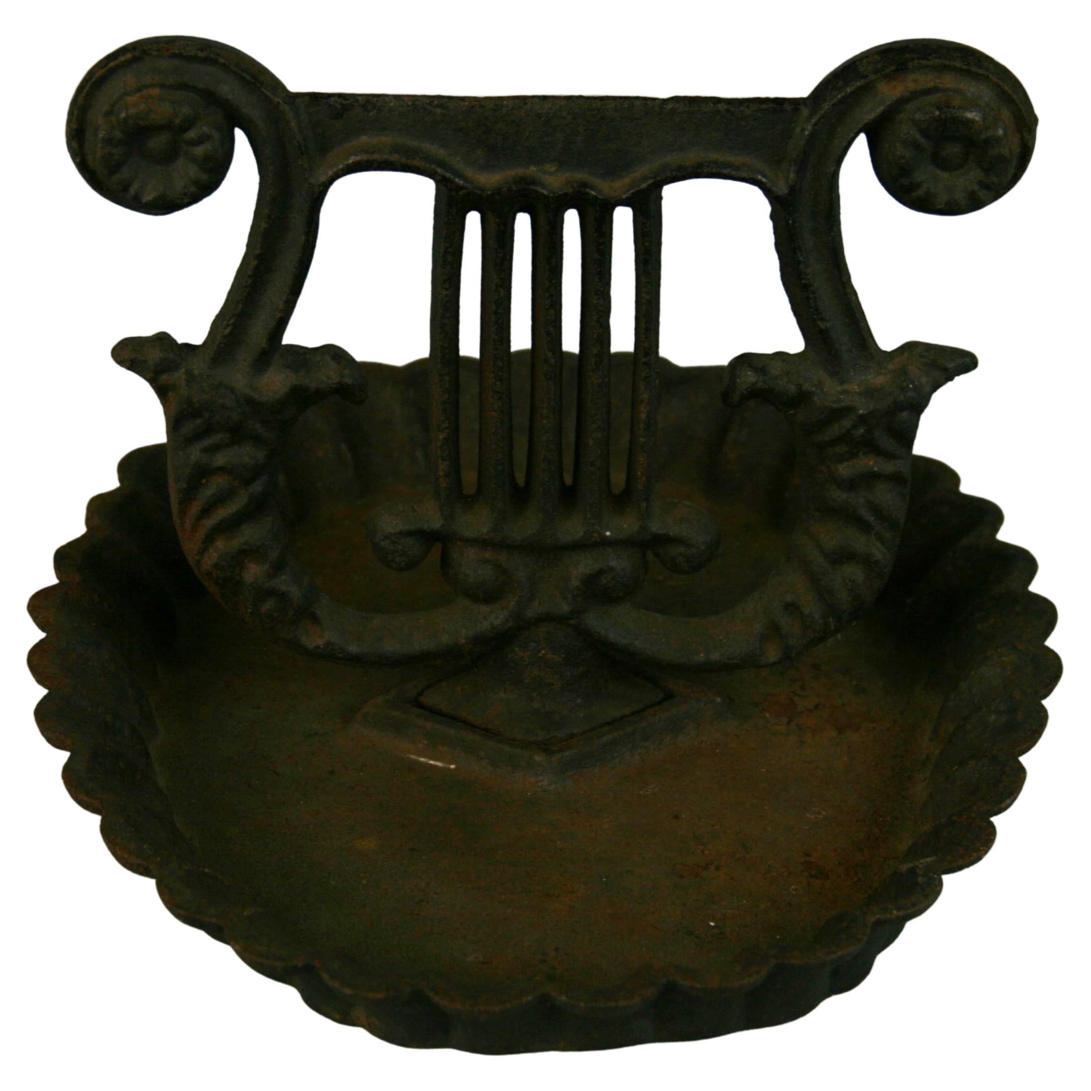 3-791 English cast iron boot scraper with harp detailing.