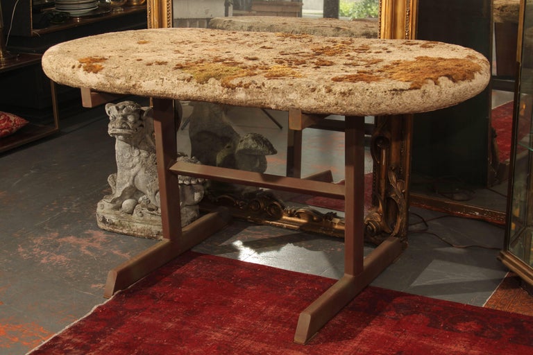 Moss covered antique cast stone top garden table on vintage metal base. Can be used inside or out- would be perfect entry table. Top is approximate 3 1/2 inch thick.
