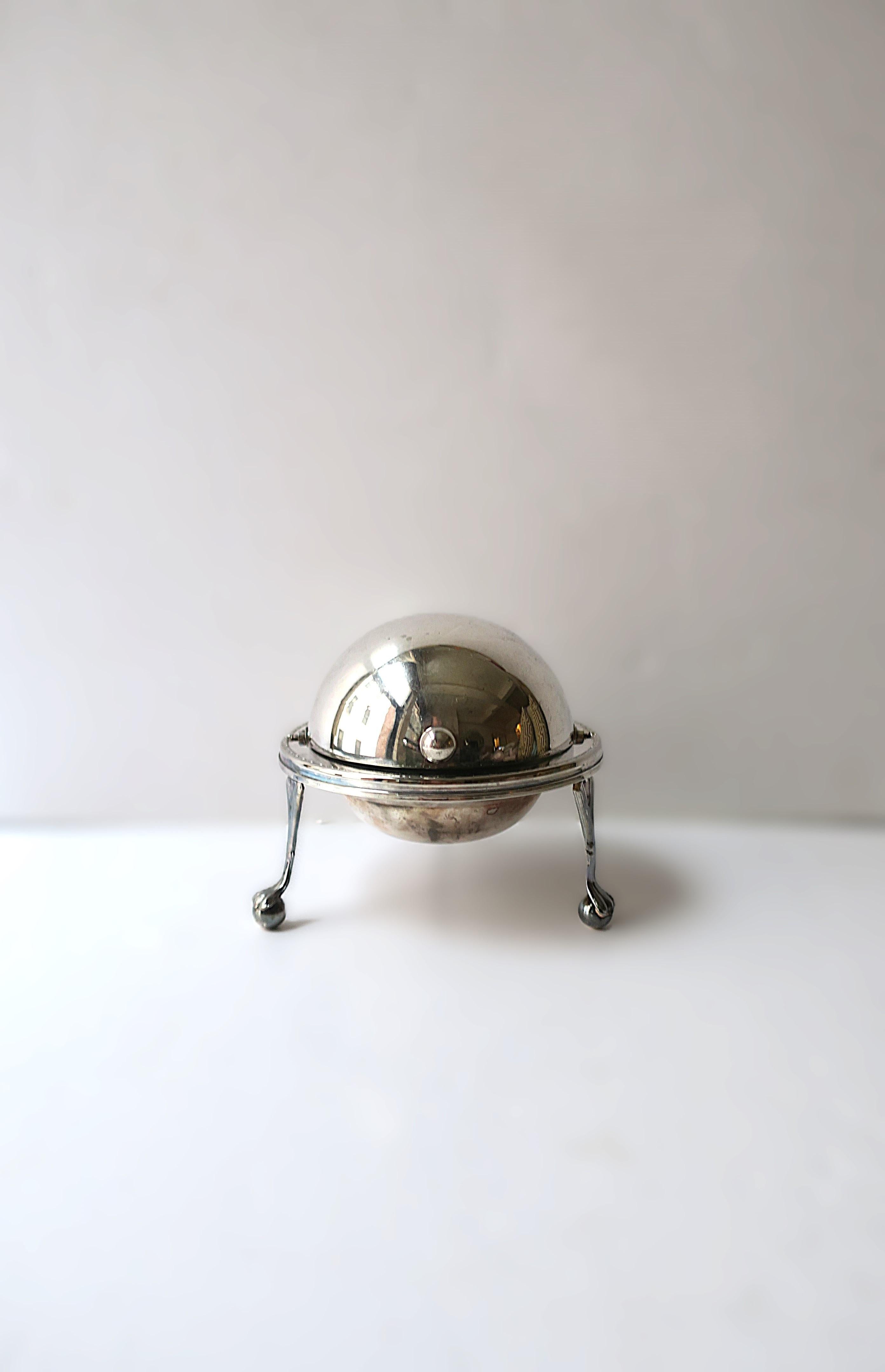 An English silver plate and glass caviar covered dish with lion paw feet, in the Empire style, circa mid-20th century, England. Piece could also be used for butter, if so desired. Piece has an easy roll top lid with cut glass dish insert, finished