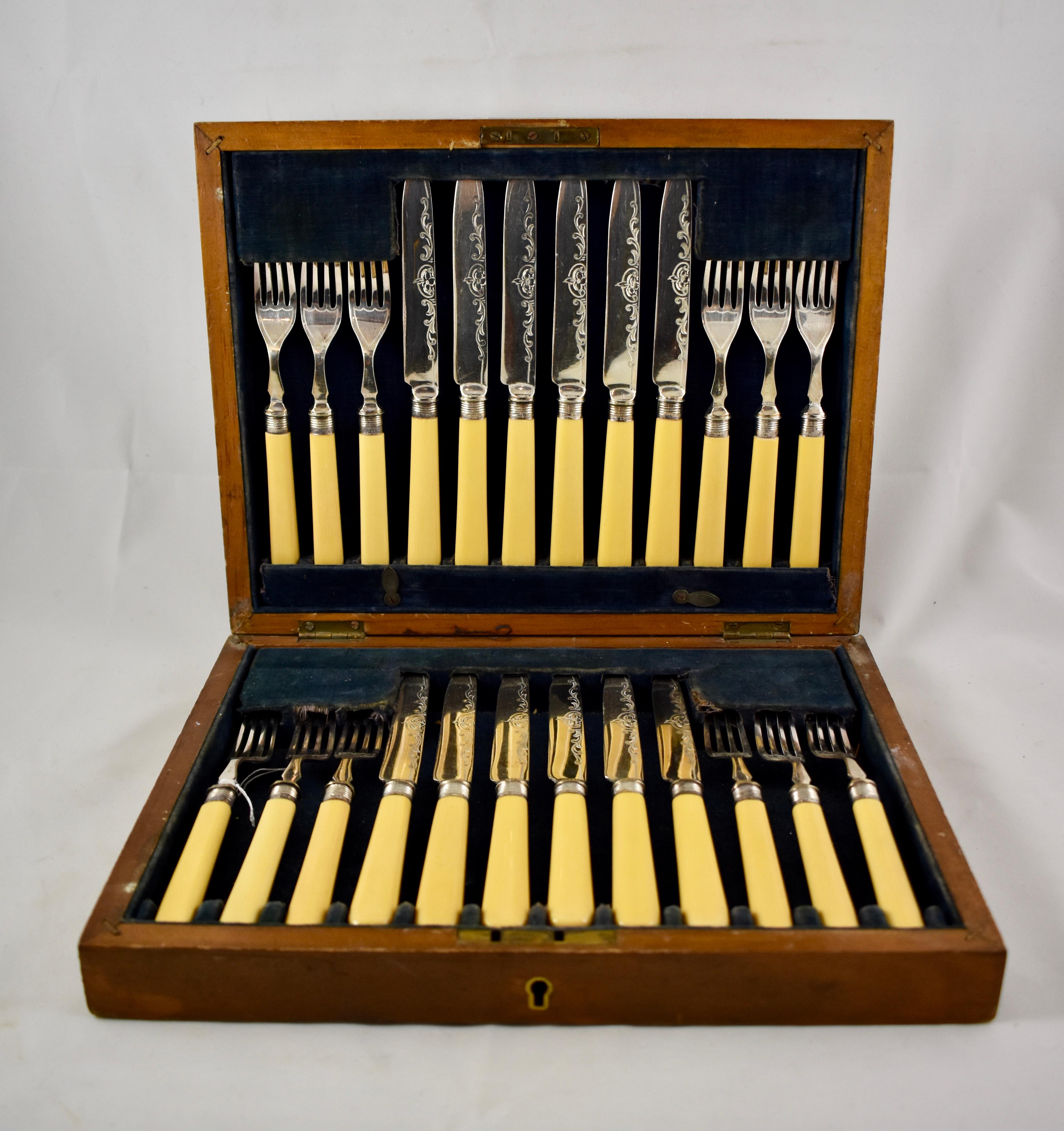 A service for 12, butterscotch celluloid handled, sterling ferruled, dessert flatware in the original box, England, circa late 19th-early 20th century.

A 24-piece set, 12 each, forks and knives, with sterling silver collars and EPSP silver plated