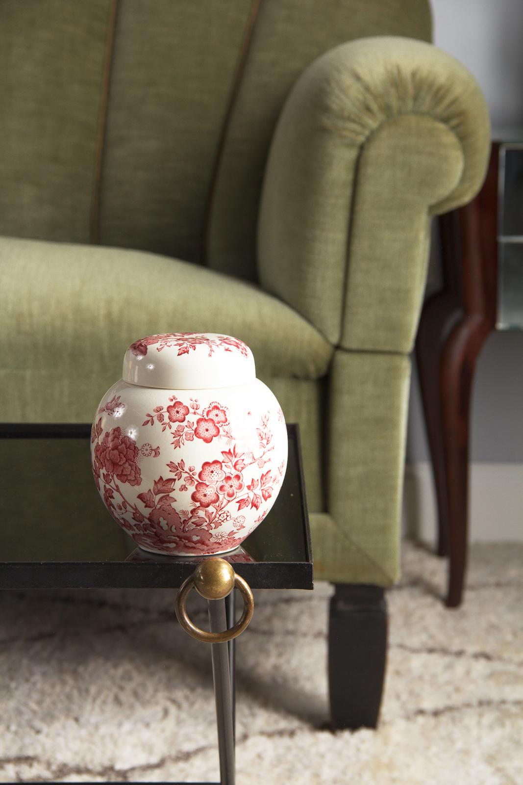 A glazed ceramic candy jar with chinoiserie style floral decoration from the Mason factory in Liverpool, England, circa 1940. Squat and round shape with a simple round cap lid, both with a clear glaze over light cream stonewear. Both lid and jar are