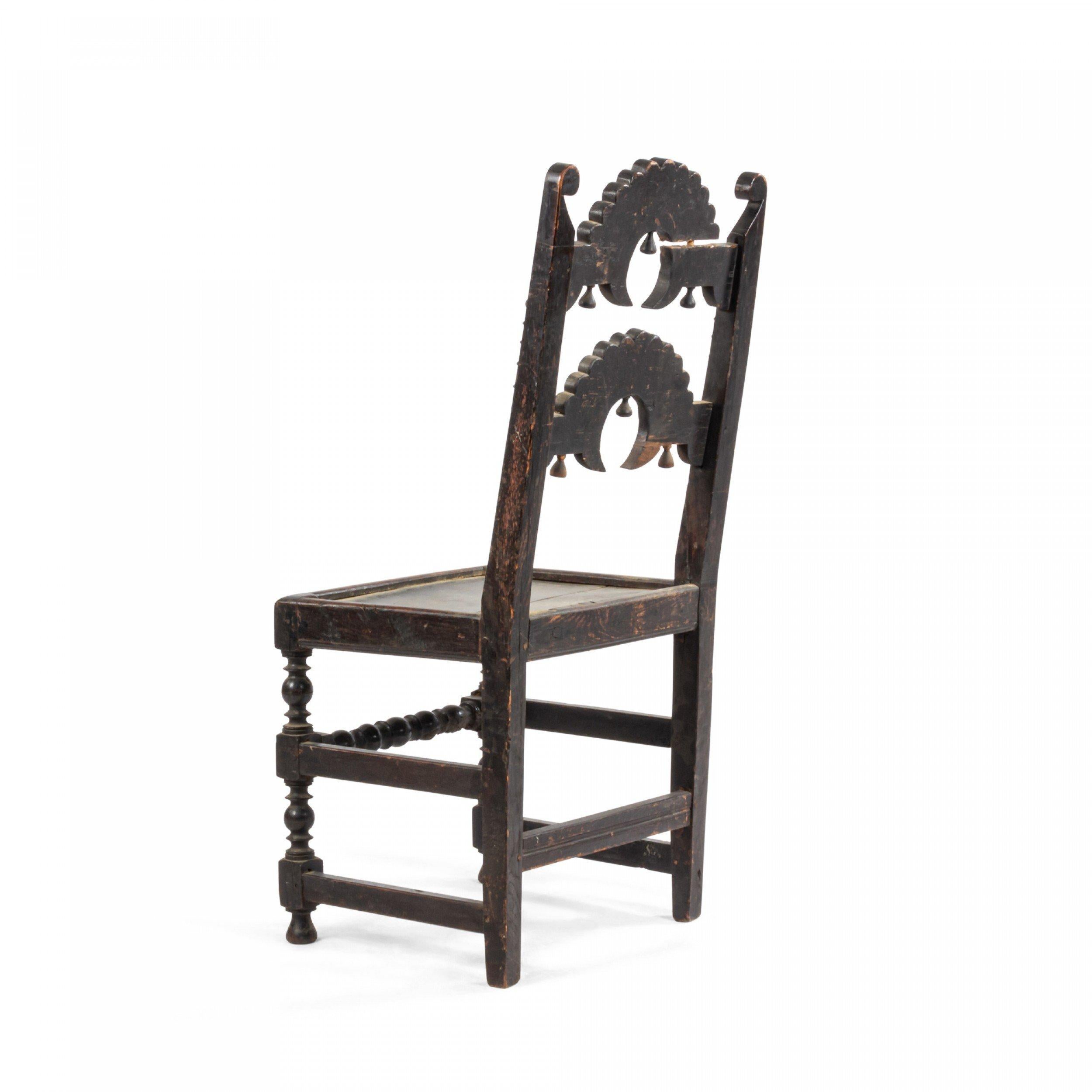 English Charles II oak 'Derbyshire' side chair with 2 arched horizontal splats above a plank seat & turned legs joined by stretchers (17th Century and Later).
 