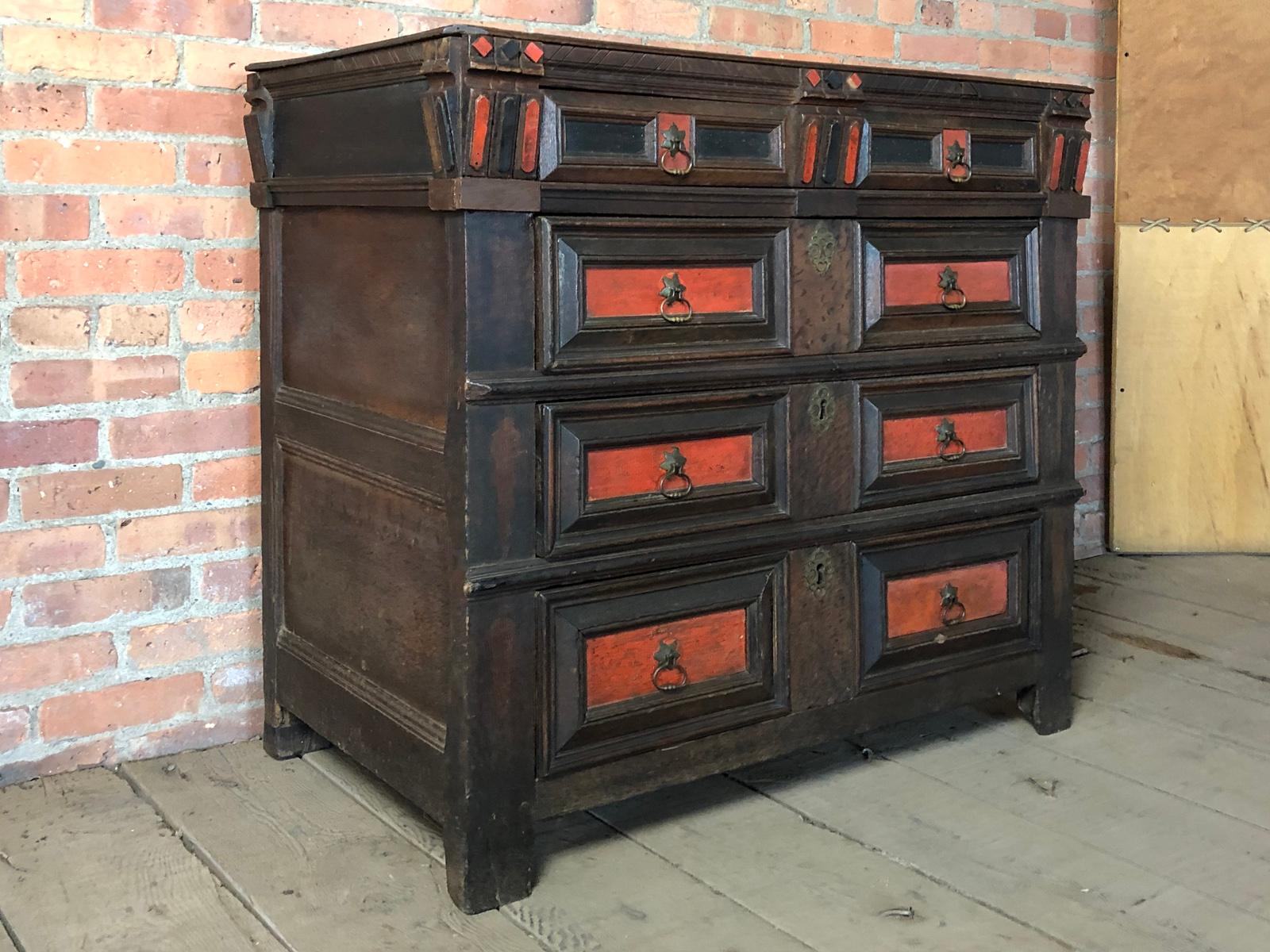 English Charles II Oak and partly stained 17th Century Commode
Made ca. 1670 likely in Dorset, the thin two-board top over four drawers, the drawer fronts accentuated by red and black stain enhancing the design, the top drawer also adorned with