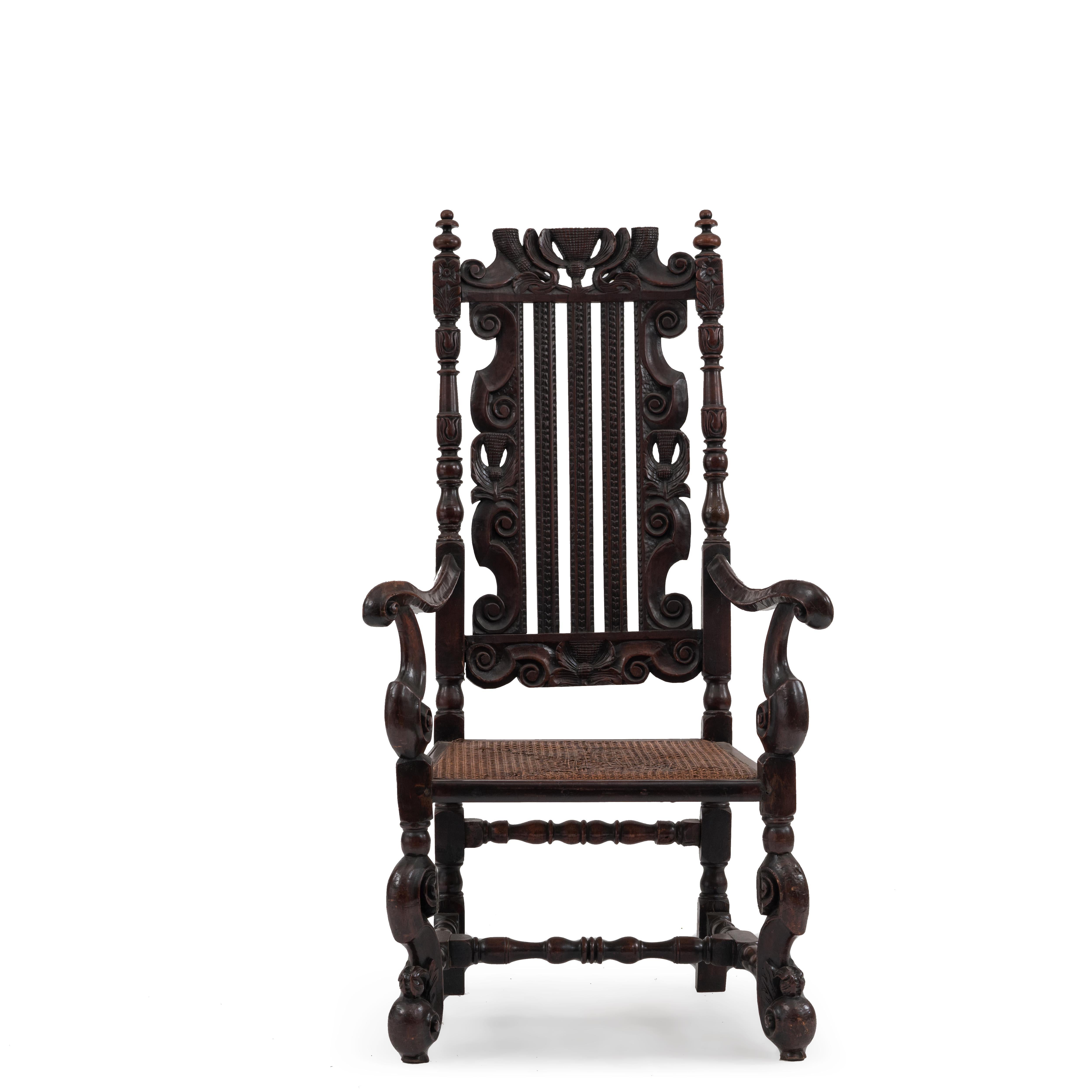 English Charles II style caned and walnut armchair with vertically slatted back above S-scroll legs joined by a stretcher. (19th century & possibly with earlier elements).