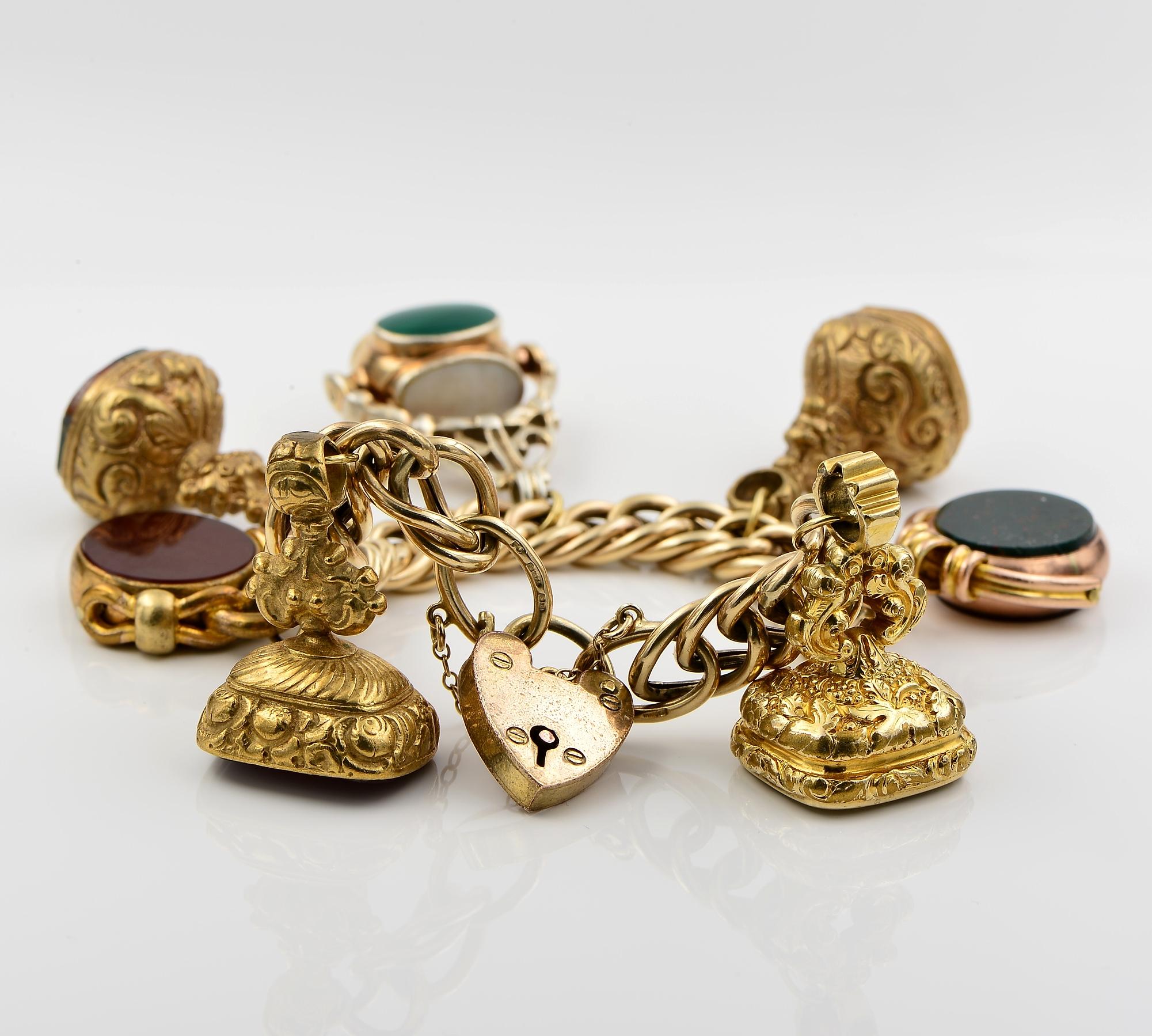 Collected with Love
This very pretty English vintage bracelet, has been loaded with a collection of antique, interesting and unique hard stone Pinchbeck or as called cased gold fobs, one in silver and one heart padlock made of Pinchbeck, all large