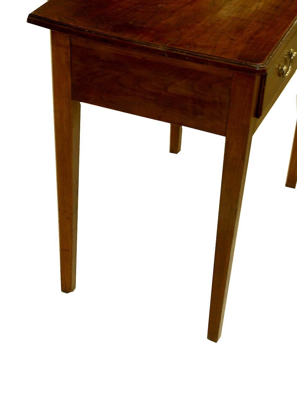 English cherry one drawer table with beautiful figured cherry top, the single drawer with original brass swan neck pulls, tapered legs.