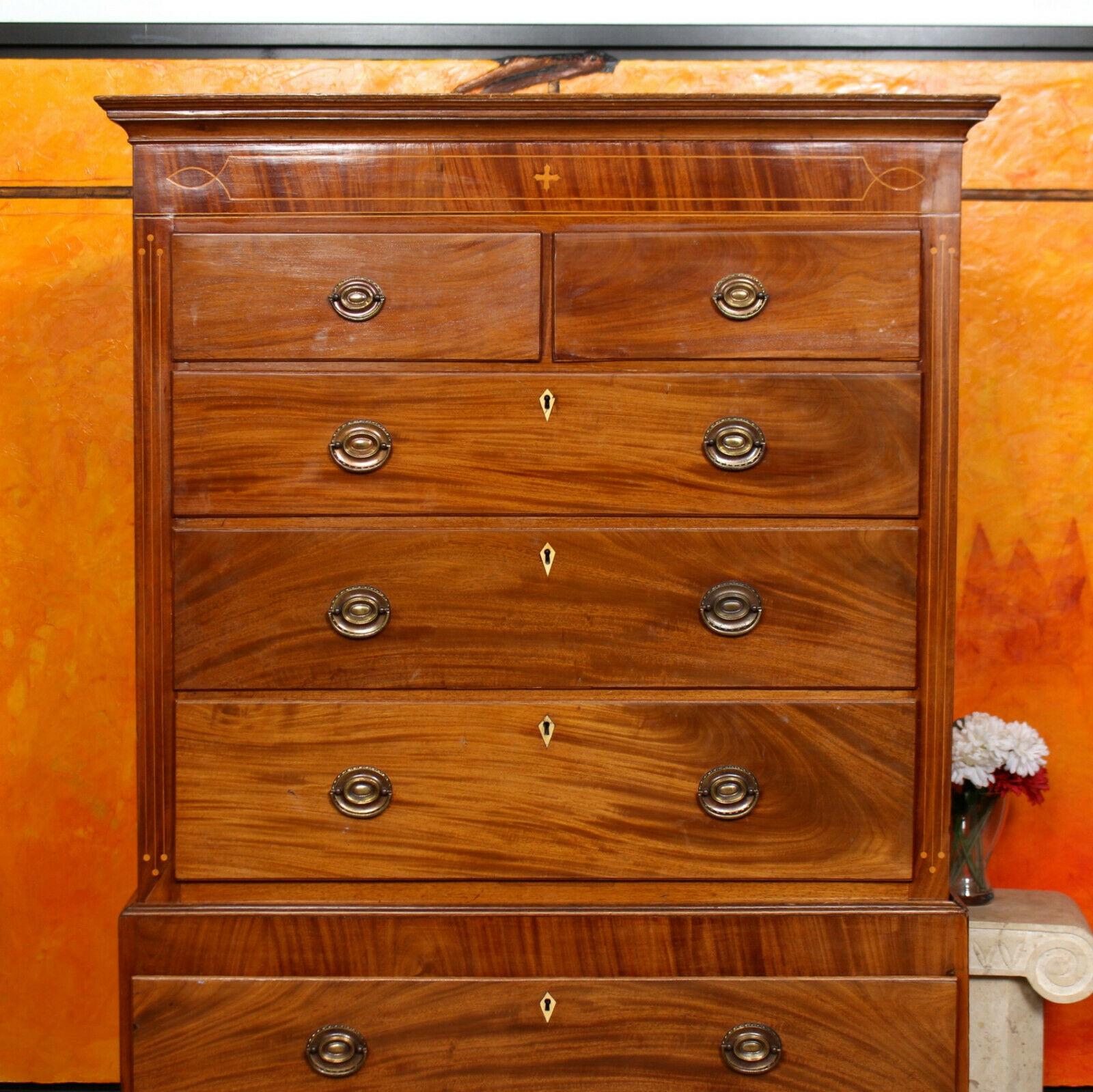 An impressive 19th century inlaid mahogany chest on chest of drawers.
The mahogany boasting a well figured wild grain and rich patina.
The cornice and satinwood banded frieze above two short and six long graduated drawers mounted with good handles