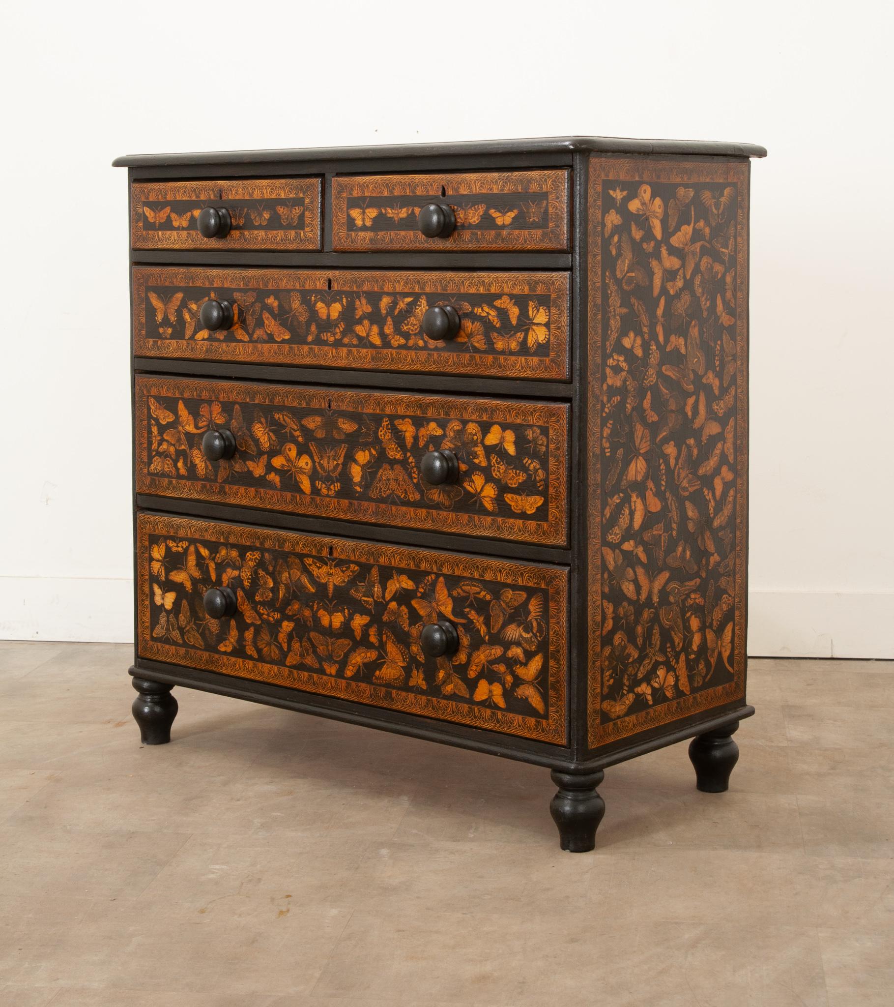 A playful twist on an antique pine chest of drawers. Recently painted black with a butterfly and moth decoupage design. This chest will add a whimsical flair to any room in your house, especially a bedroom as there is plenty of storage inside its
