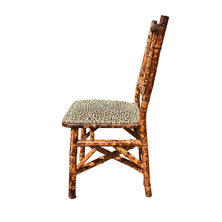 English small children’s burnt bamboo (also known as tortoise shell bamboo) chair. This small chair is created from bamboo with a mixture of black and light brown colors. Chairs like this are a rare find, and even more so the children’s version.