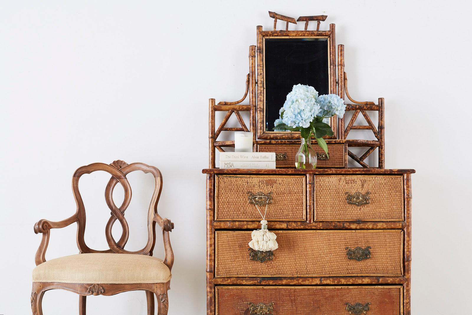 Charming English chinoiserie dressing table featuring a tilt beveled mirror and shelf. Constructed from beautiful tortoiseshell bamboo poles and finished with raffia grasscloth covered surfaces. The chest is fronted by five large storage drawers