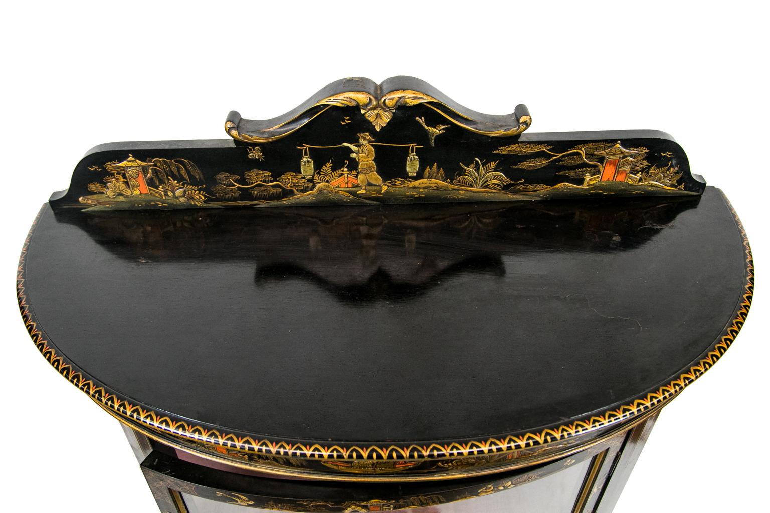 English Chinoiserie display case, the sides and front are curved, creating a demilune front. The inside has fabric upholstery.
