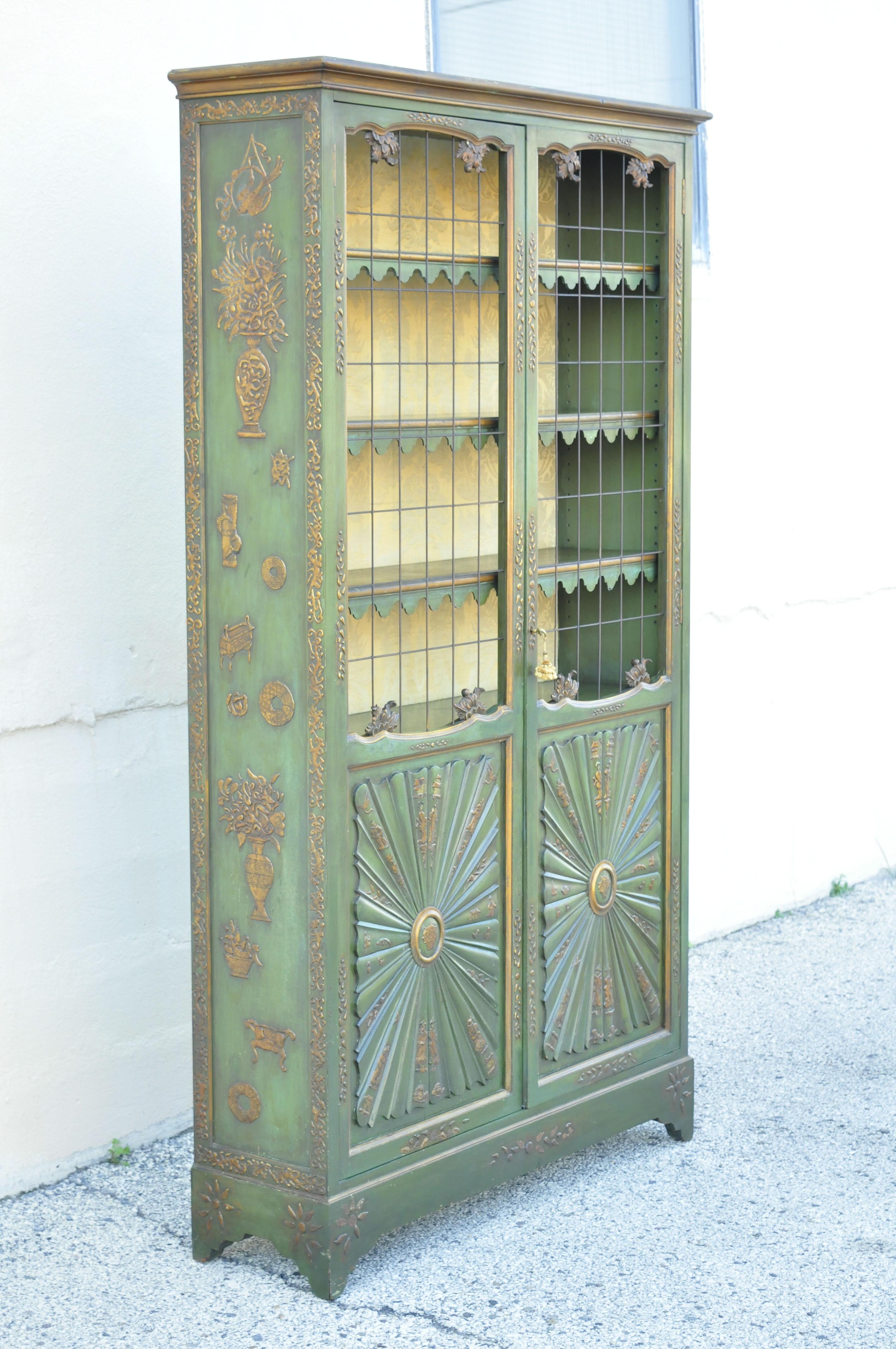 Vintage English Chinoiserie style green distress painted tall George III Curio display cabinet. Item features green and gold distress painted finish, decorative figures/scenes throughout, tall stately form, metal grill, gold upholstered interior,