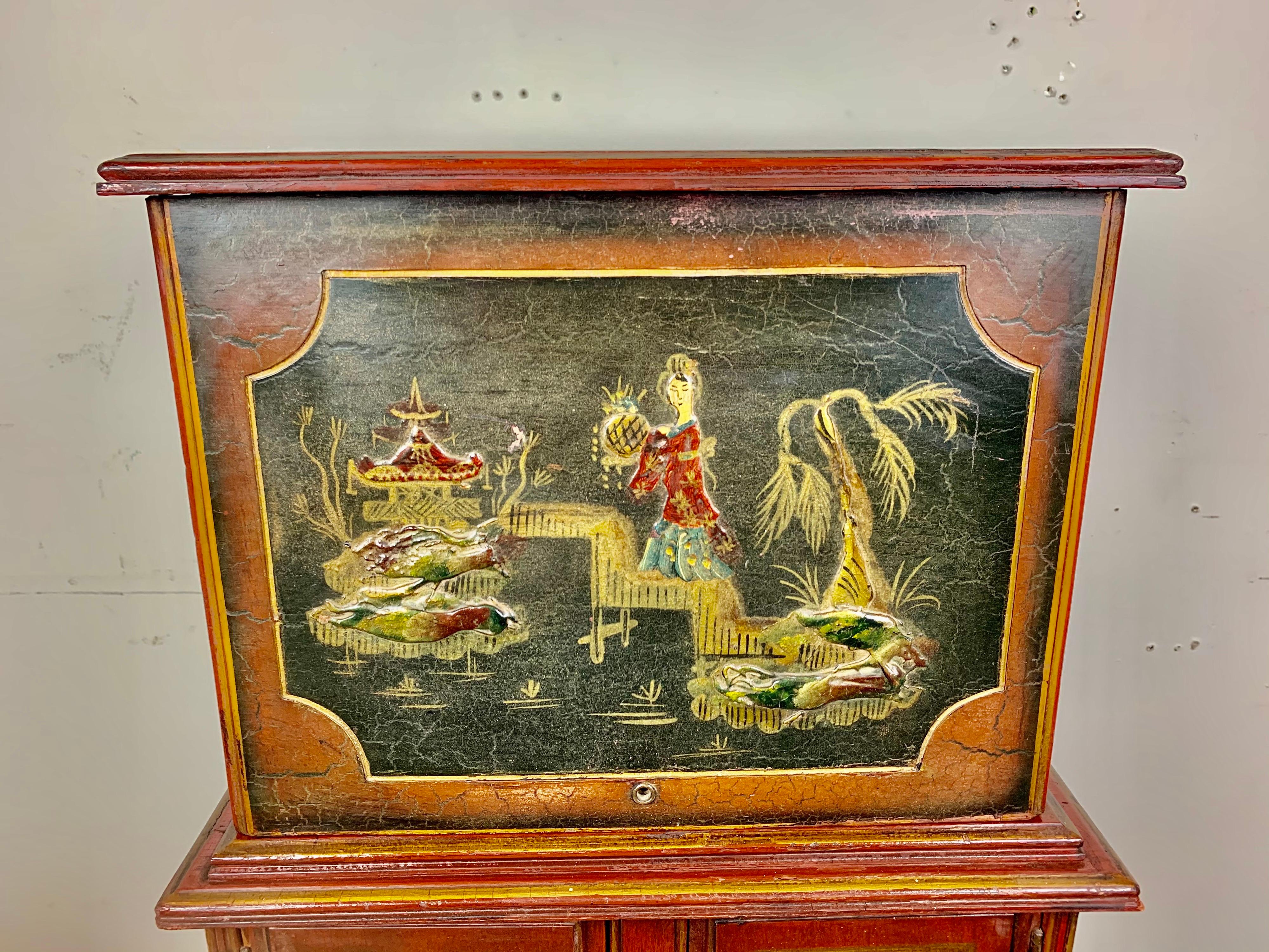 Hand painted English chinoiserie painted smoking cabinet, circa 1930s. Beautiful chinoiserie decoration including figures, pagodas, bridges, and so much more.