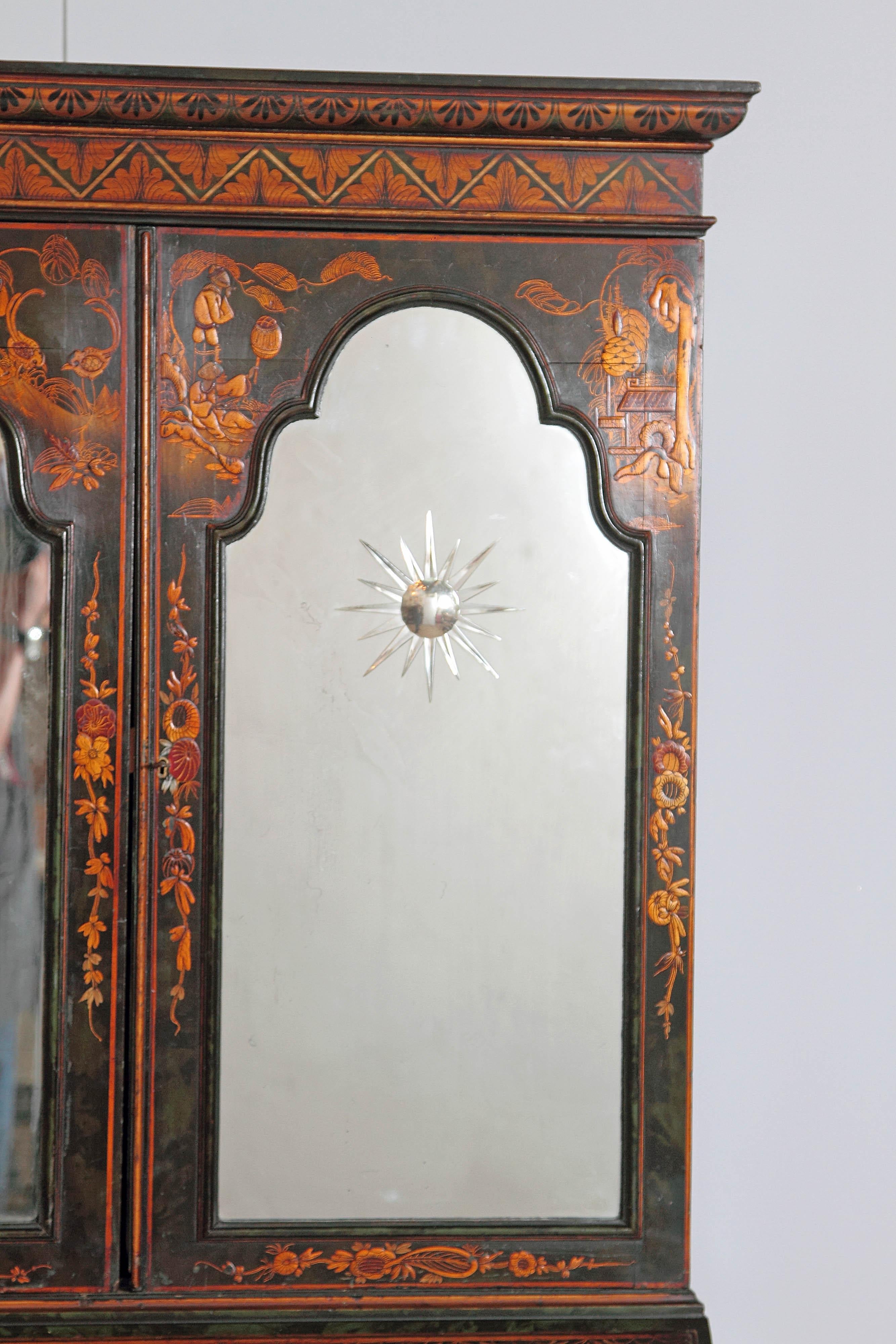 This early 20th century five-drawer secretary is made of wood stained in a deep black color with chinoiserie. Adorning the facade of the secretary are intricate painted scenes of Chinese pastoral life. The sides have gold painted floral designs. The