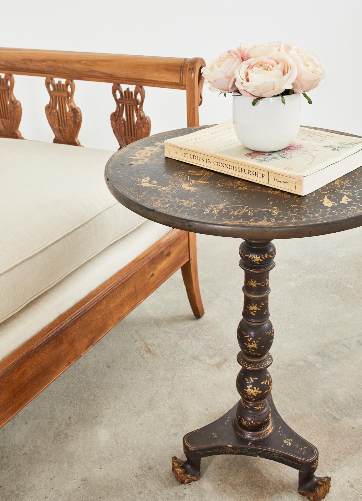 19th century Engish tilt-top pedestal table made in the Chinoiserie revival period. The round table features a birdcage base support mounted to a pedestal style turned column ending with tripod legs. The legs end with claw style feet. The table has