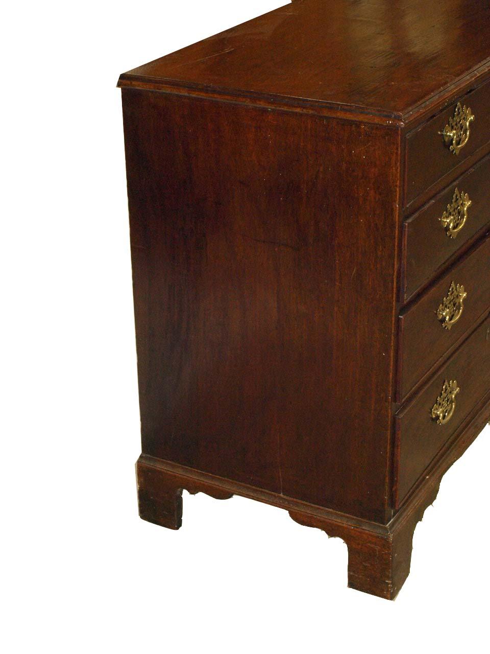 English Chippendale bachelor's chest, the two over three drawers with open fretwork brass pulls that are not original but are handmade copies of an original 18th century pull; this chest retains it's original finish, and the bracket feet are also